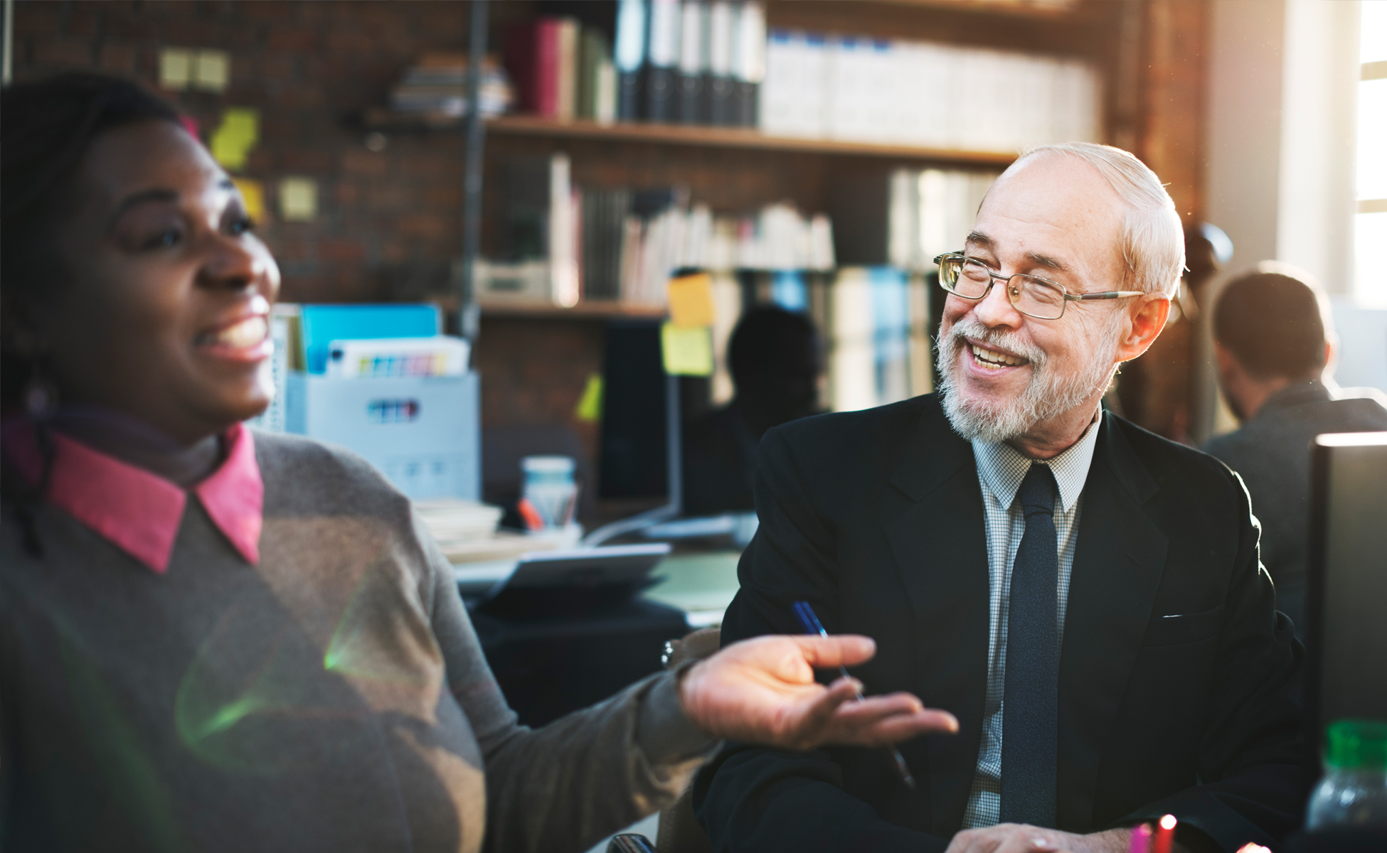 Manager listening to employees during an inclusive workplace discussion