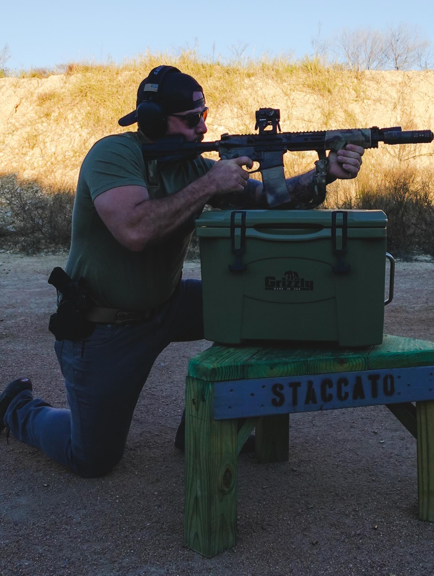 Shawn in tactical position aiming a gun