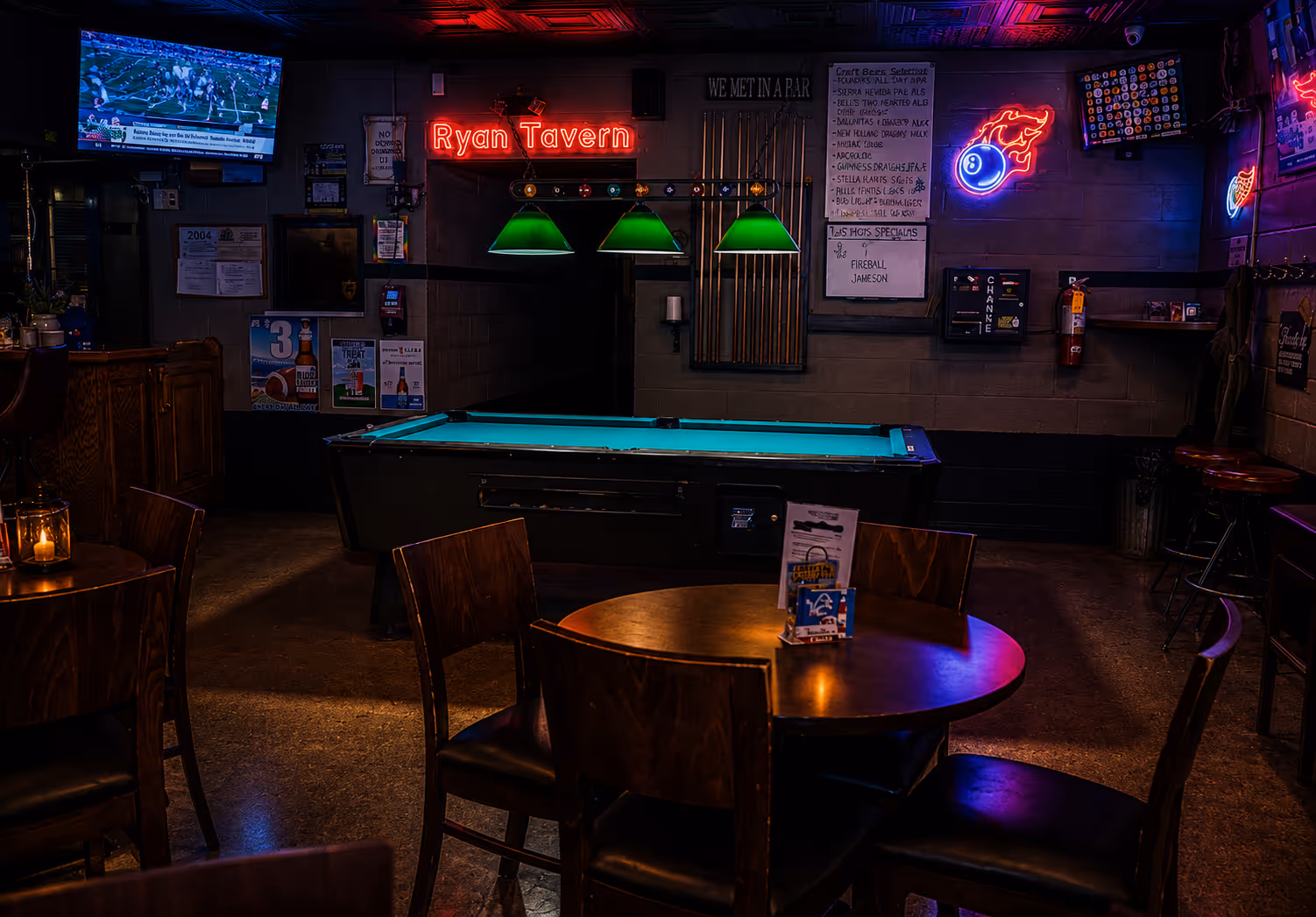 A pool table with a green pool in a bar.