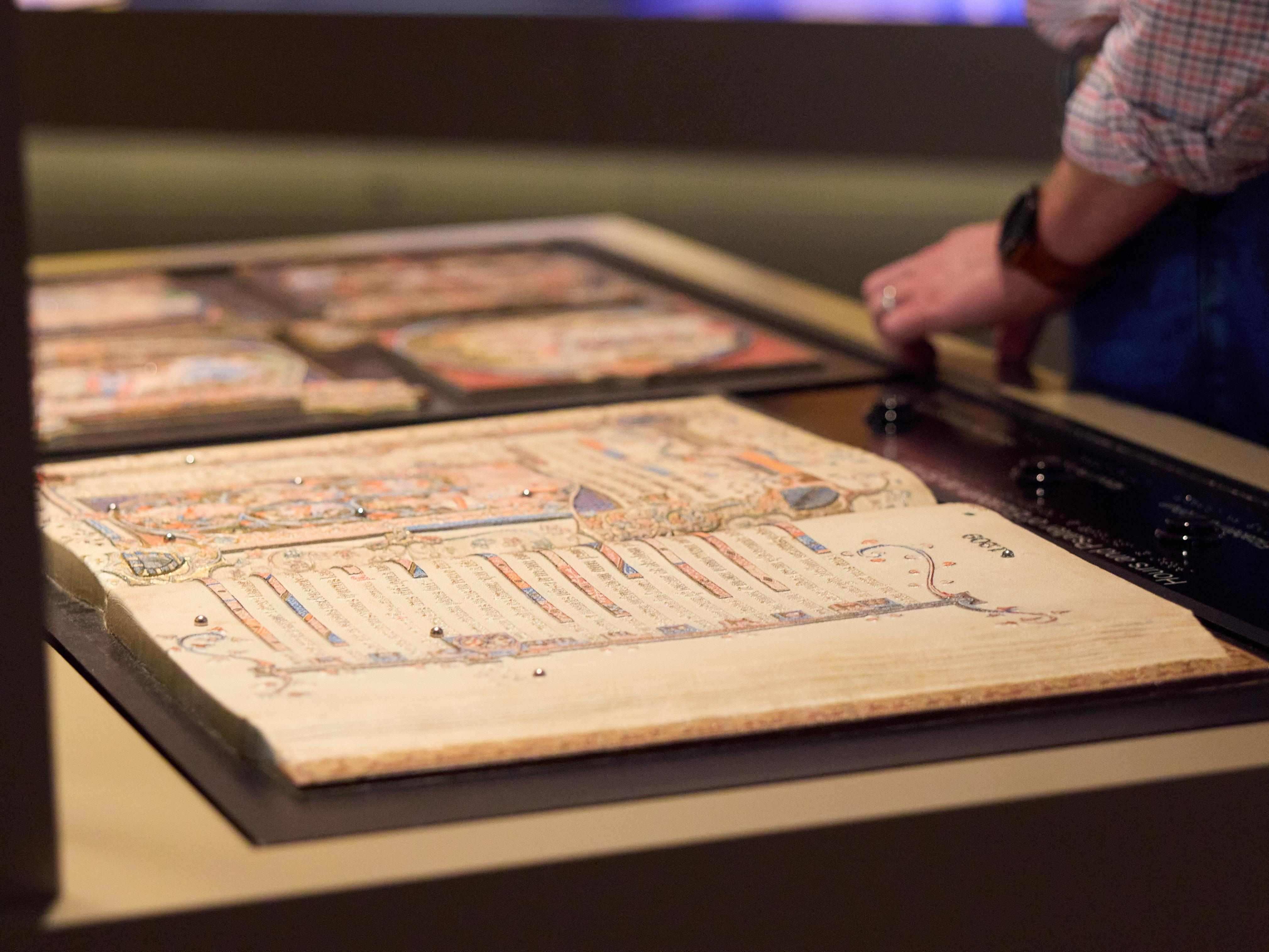 An illuminated medieval Gospel manuscript displayed at the Museum of the Bible in Washington, D.C., featuring ornate artwork and decorative script.