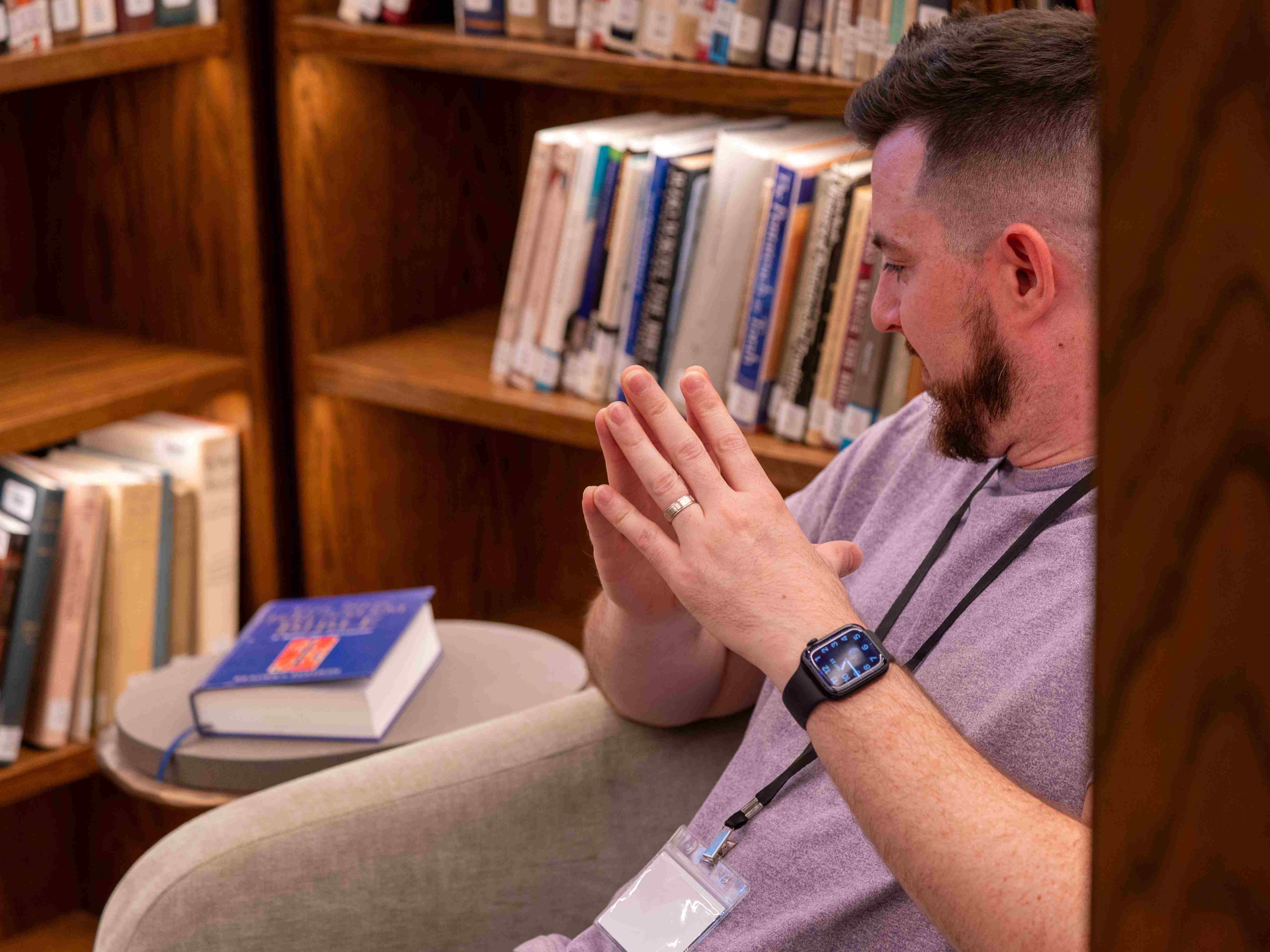 A student pauses to pray before reading the Bible in the library at Yarnton Manor near Oxford, England.