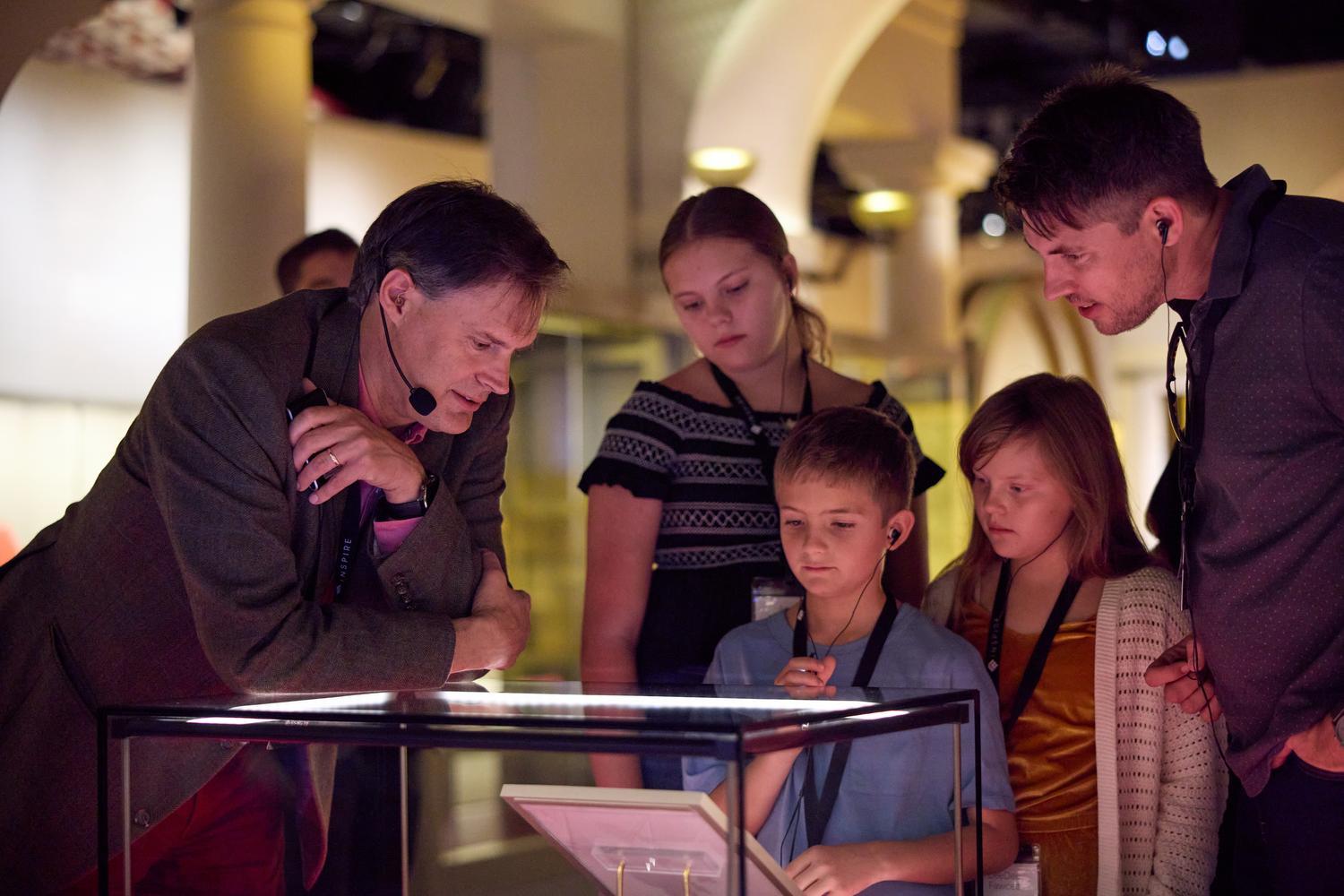 Dr. Peter Williams shows guests a Greek New Testament manuscript during a special Inspire tour at the Museum of the Bible.