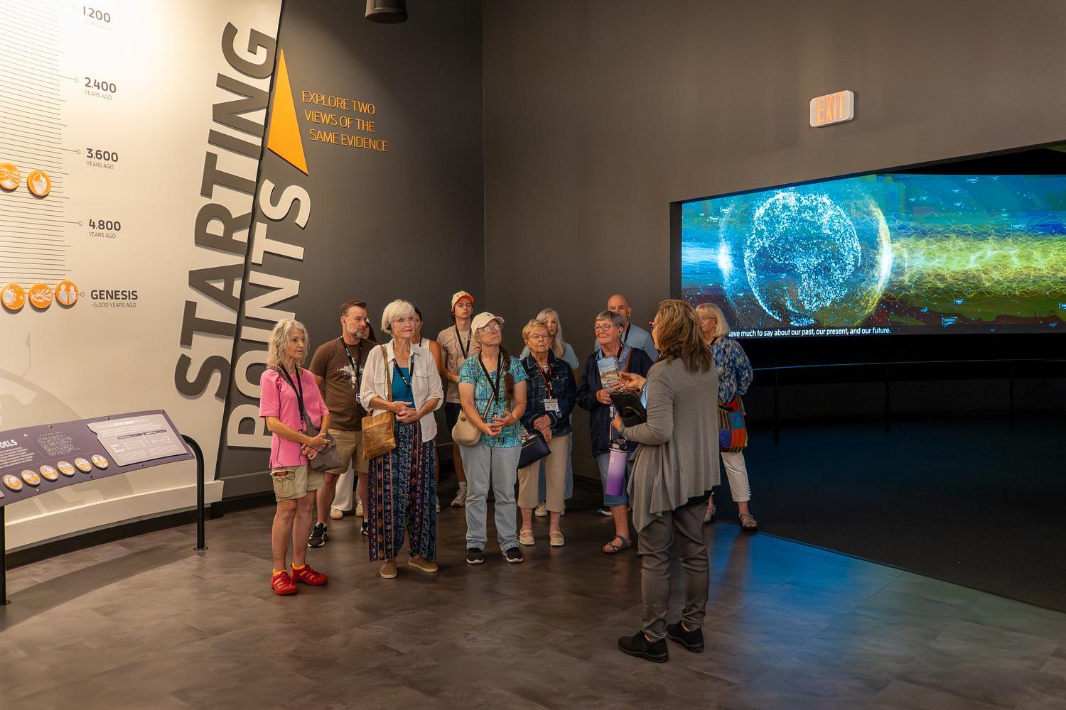 An Inspire guide introduces guests to the Creation Museum's Starting Points exhibit, exploring two different interpretations of the same scientific evidence through the lens of biblical history.