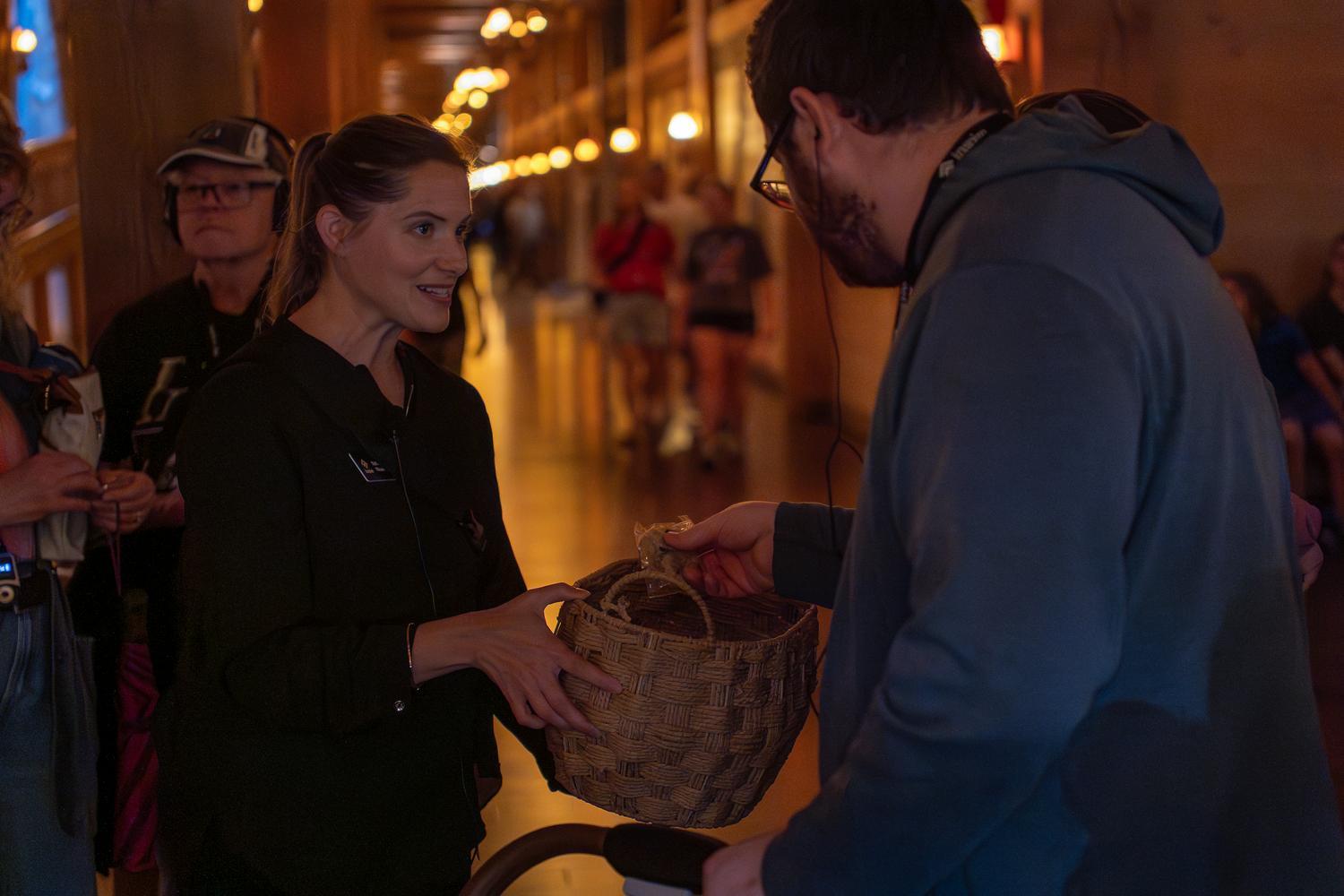 An Inspire guide hands an Ark Encounter guest an Uncle Leroy cookie during a guided tour aboard Noah's Ark.