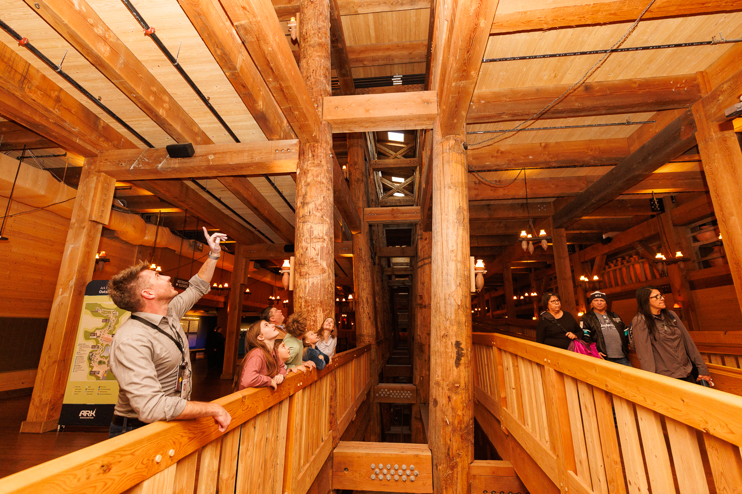 An Inspire guide explains the massive timber framework of Noah's Ark as guests look up during a guided tour inside the Ark Encounter.