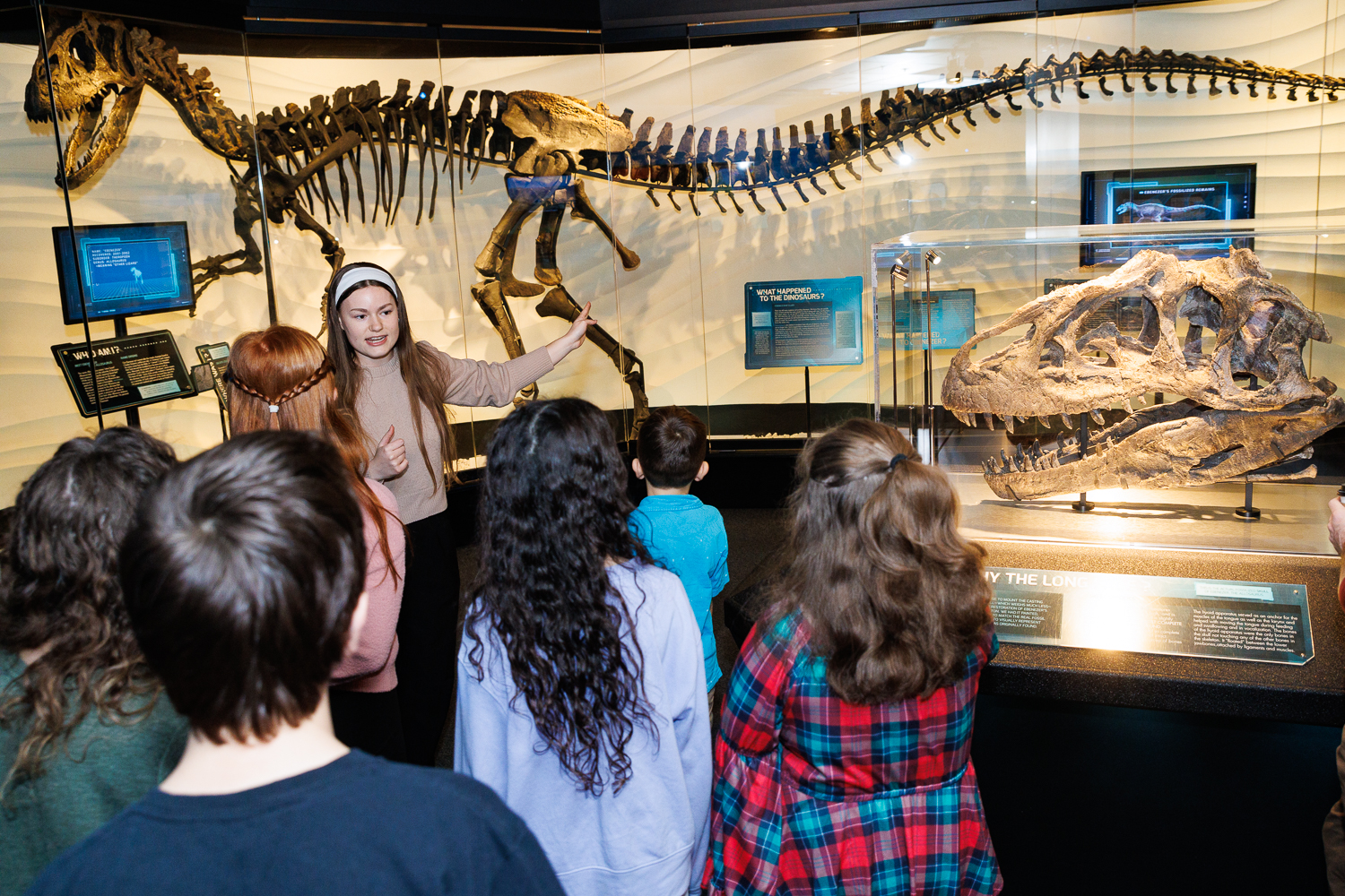 An Inspire guide teaches guests about Ebenezer, the Allosaurus exhibit, during a guided Creation Museum tour in Petersburg, Kentucky.
