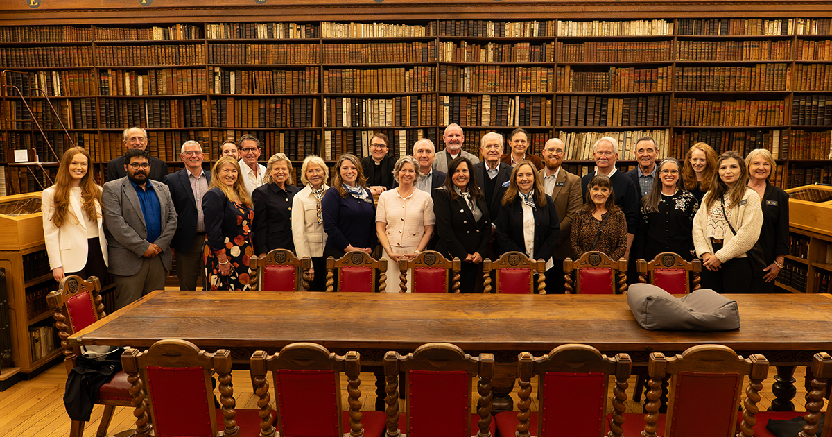 Guests and biblical scholar Dr. Peter Williams gather in the Fellows' Library at Clare College, Cambridge, England, during an Inspire educational experience.