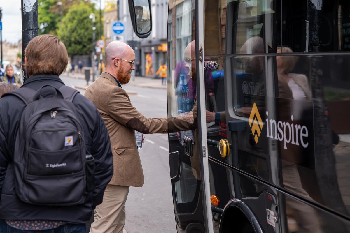 An Inspire guest boards the group's coach during an England experience, preparing to explore biblical history and Christian scholarship.