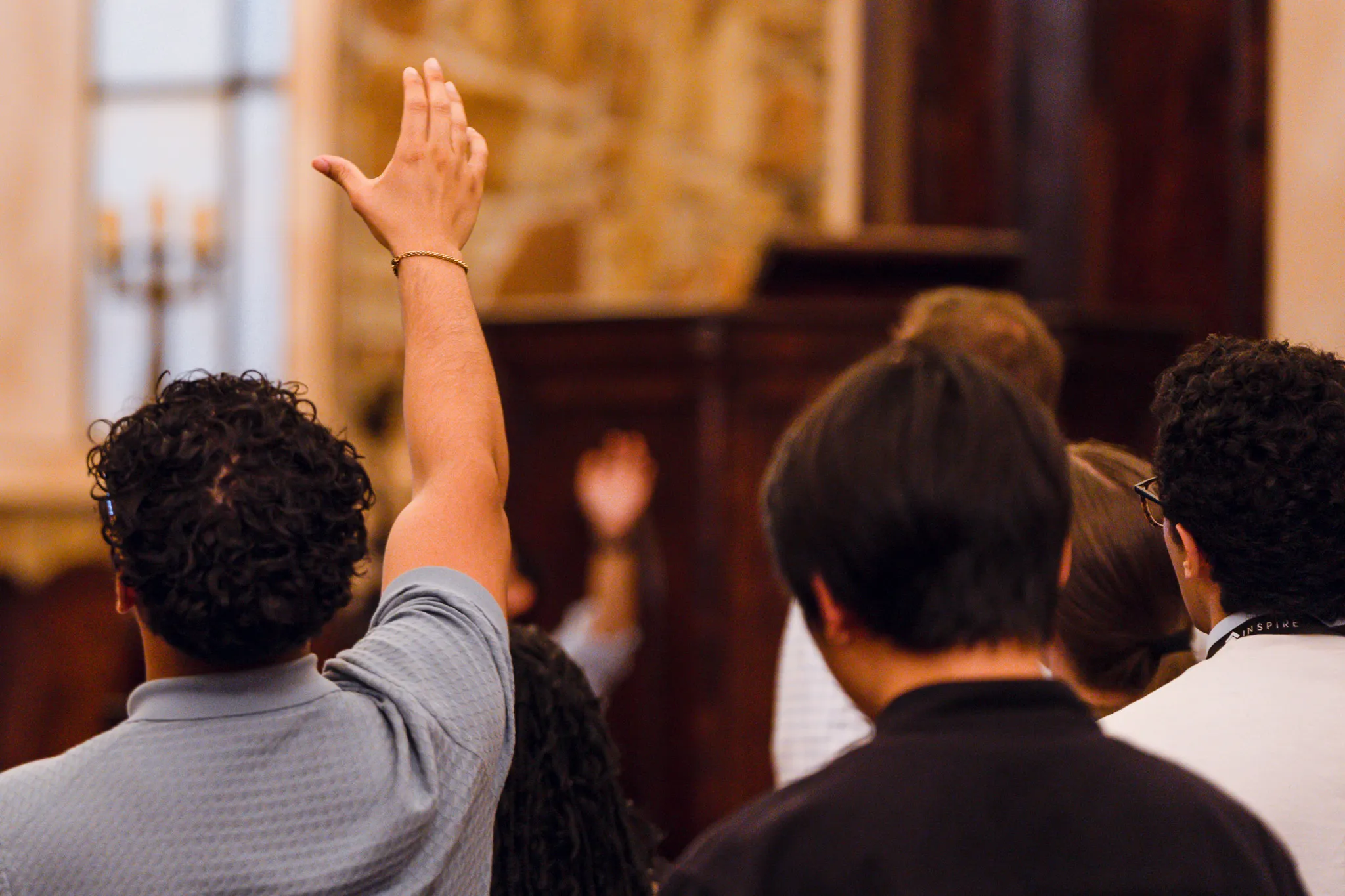 A participant raises his hand during a Christian Mind Project gathering at Lanier Theological Library in Houston, TX.