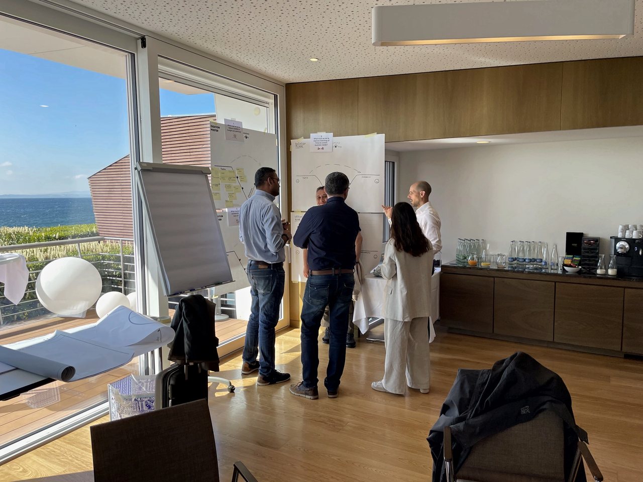 A leadership team reviewing a shared plan on the wall
