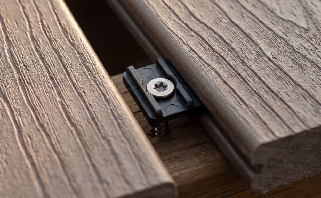 Trex Hideaway hidden fastener clip with a preset stainless screw, the kind driven with a star bit from above.