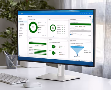 Computer monitor on desk displaying a dashboard with charts and graphs in a bright office.