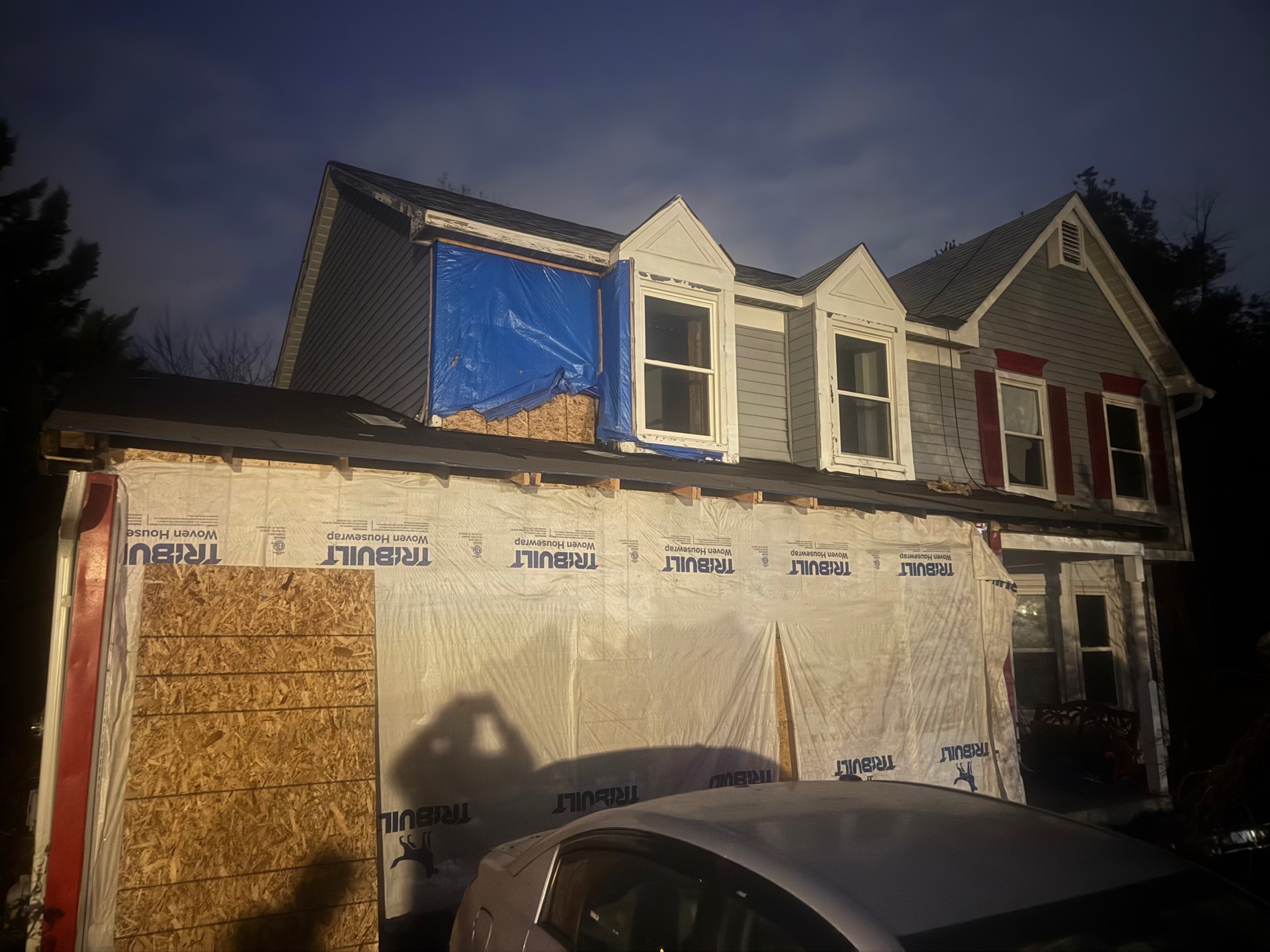 Emergency board-up and housewrap on a fire-damaged home after an after-hours call-out