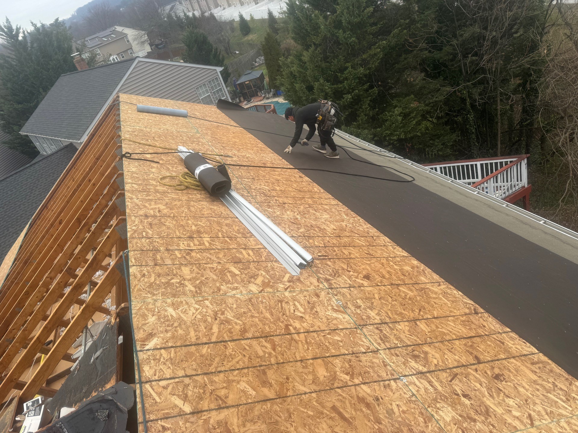 Roof replacement underway, with new decking and underlayment being installed