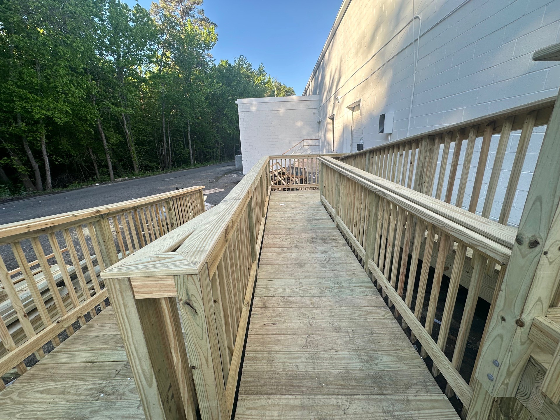 Accessible timber ramp and handrails under construction at a commercial building