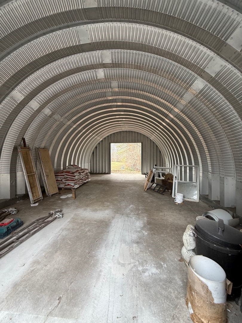 Interior of a completed arch steel building with a finished concrete floor