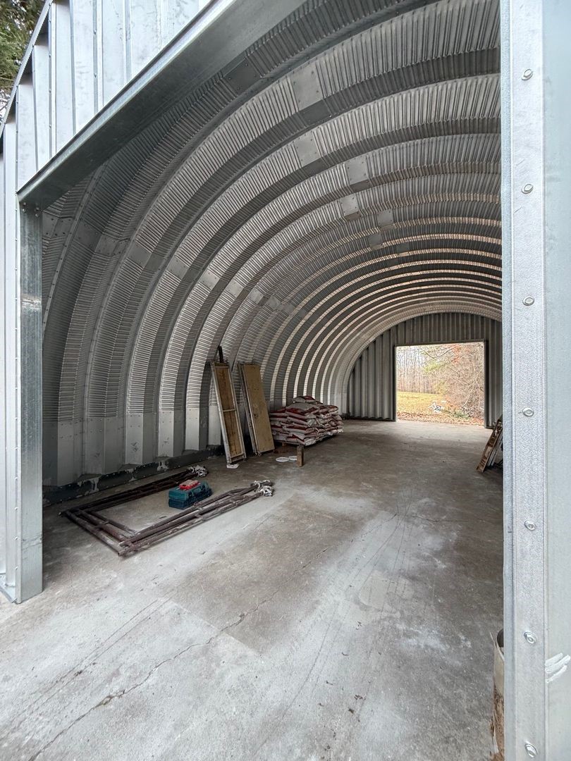 Wide interior view of a finished arch steel building