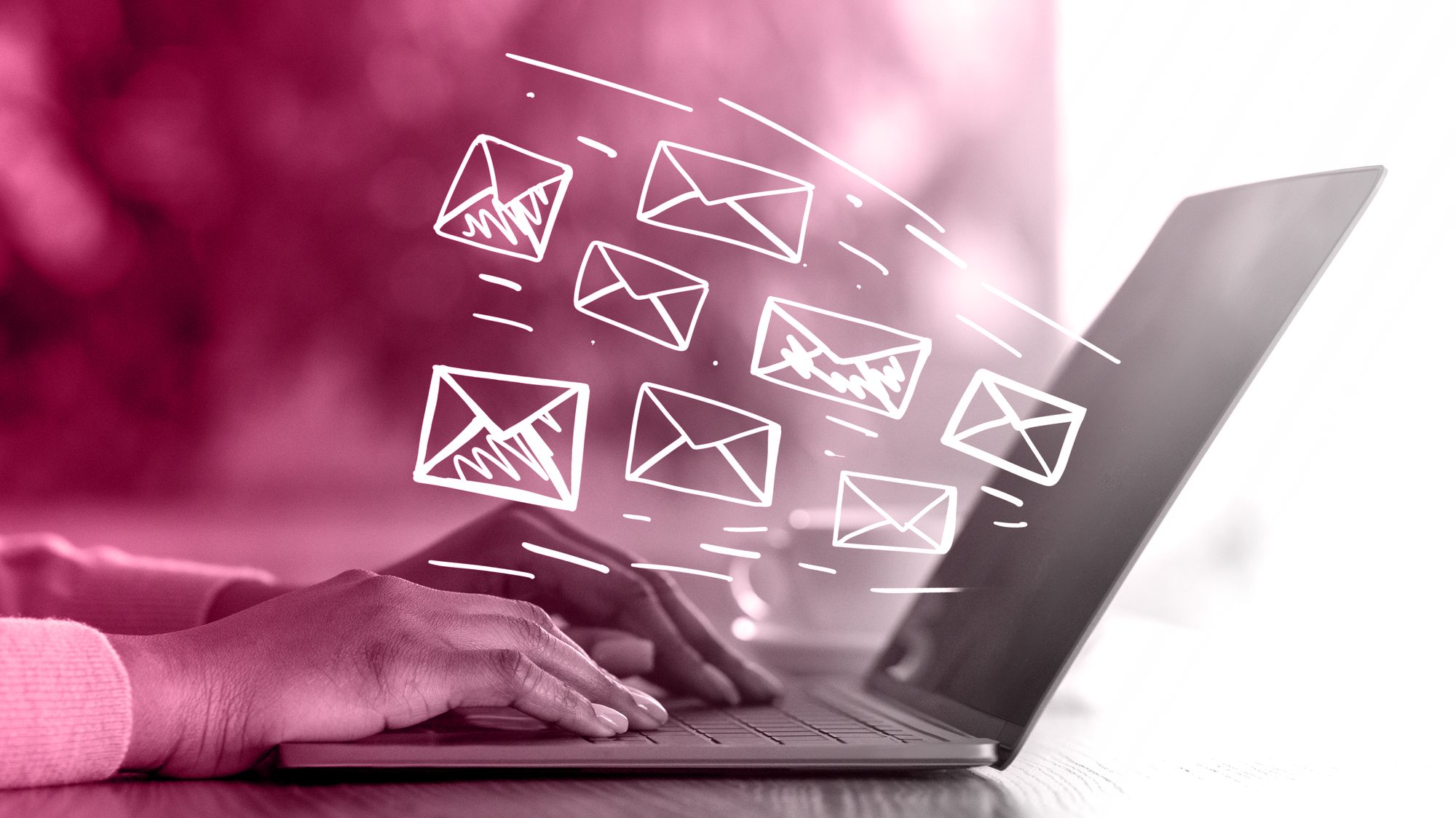 Hands typing on a laptop with email envelopes flying out, representing CRM and email integration
