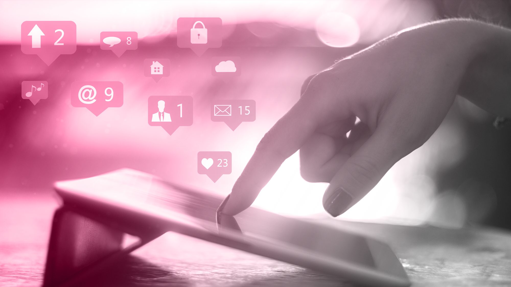 Finger tapping a tablet with social media notification icons, representing social media advertising