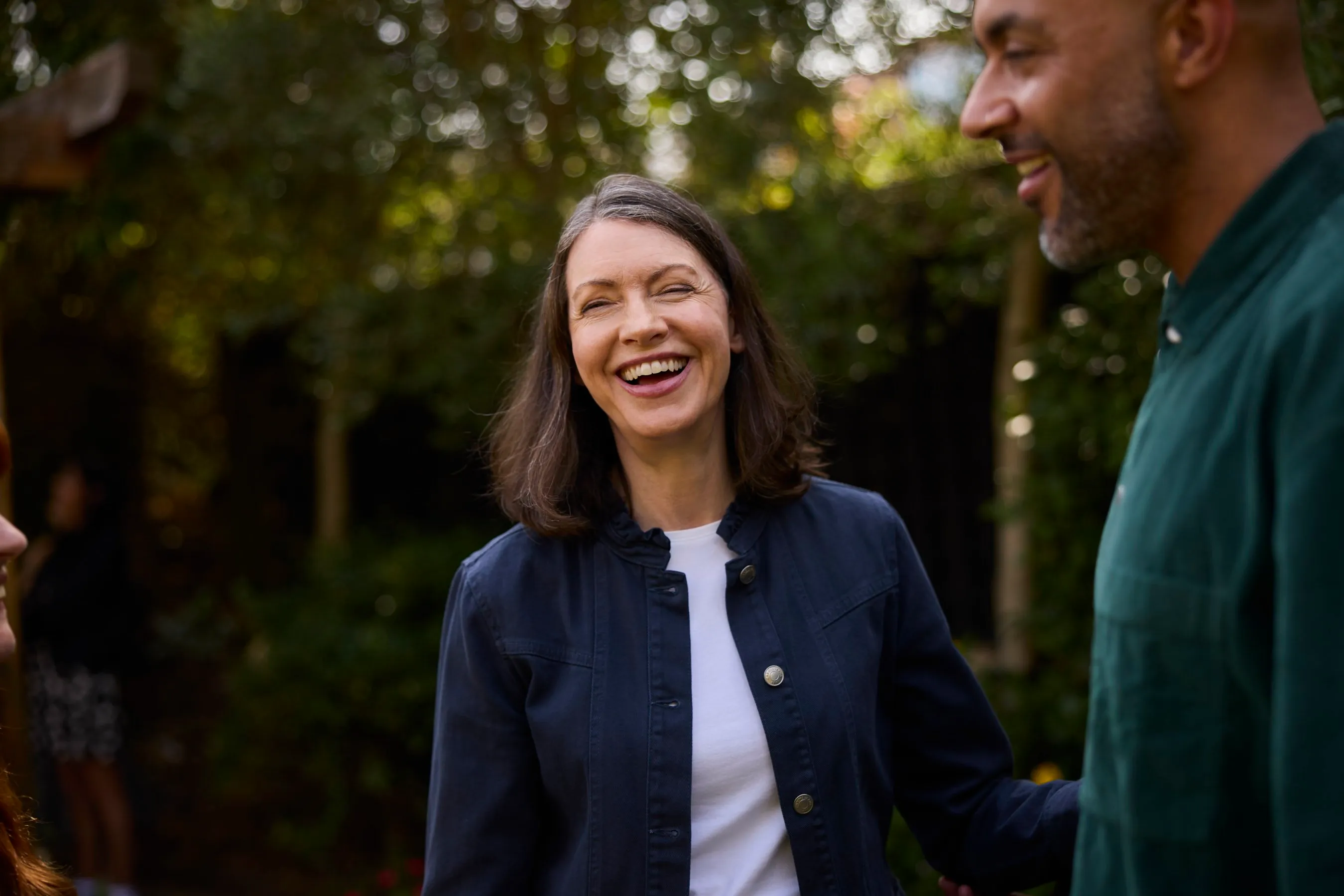 A couple laughing outdoors