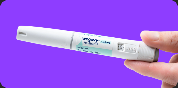 A hand holding the Wegovy FlexTouch pen