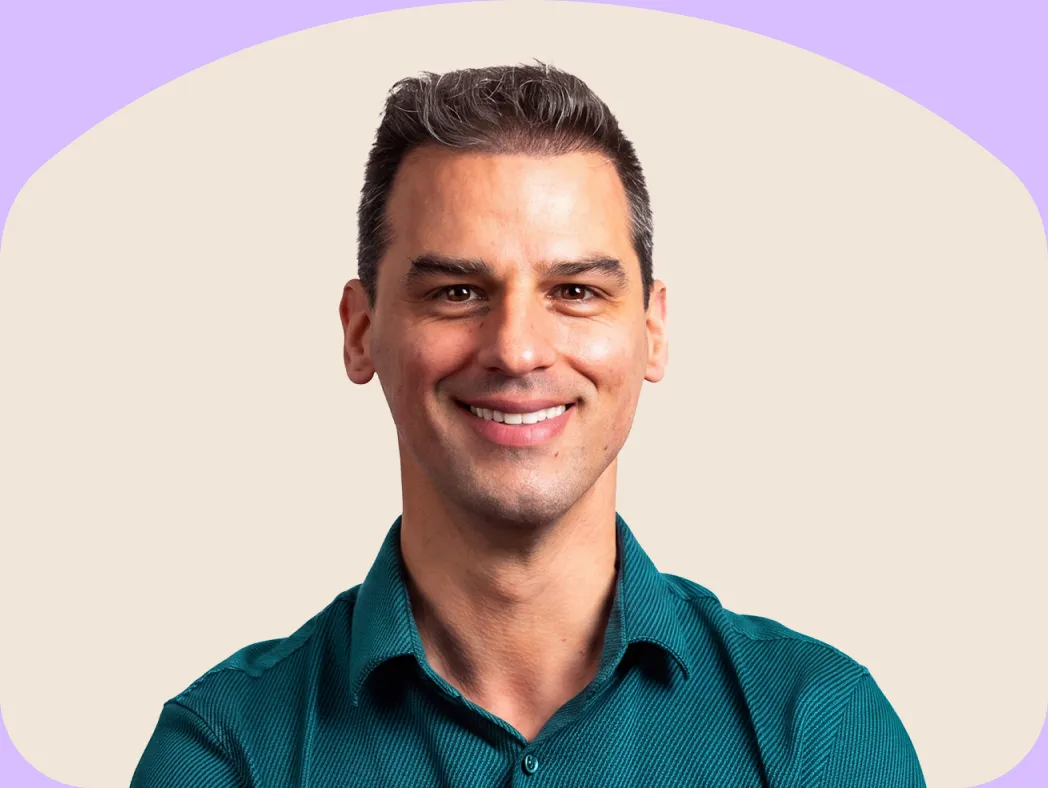 A CheqUp Clinician smiling, framed in a sand arch