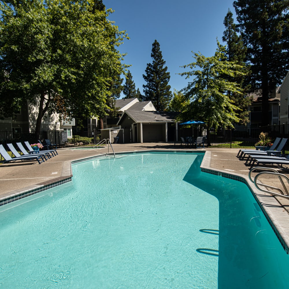 Swimming pool with lounge chairs and view of exterior