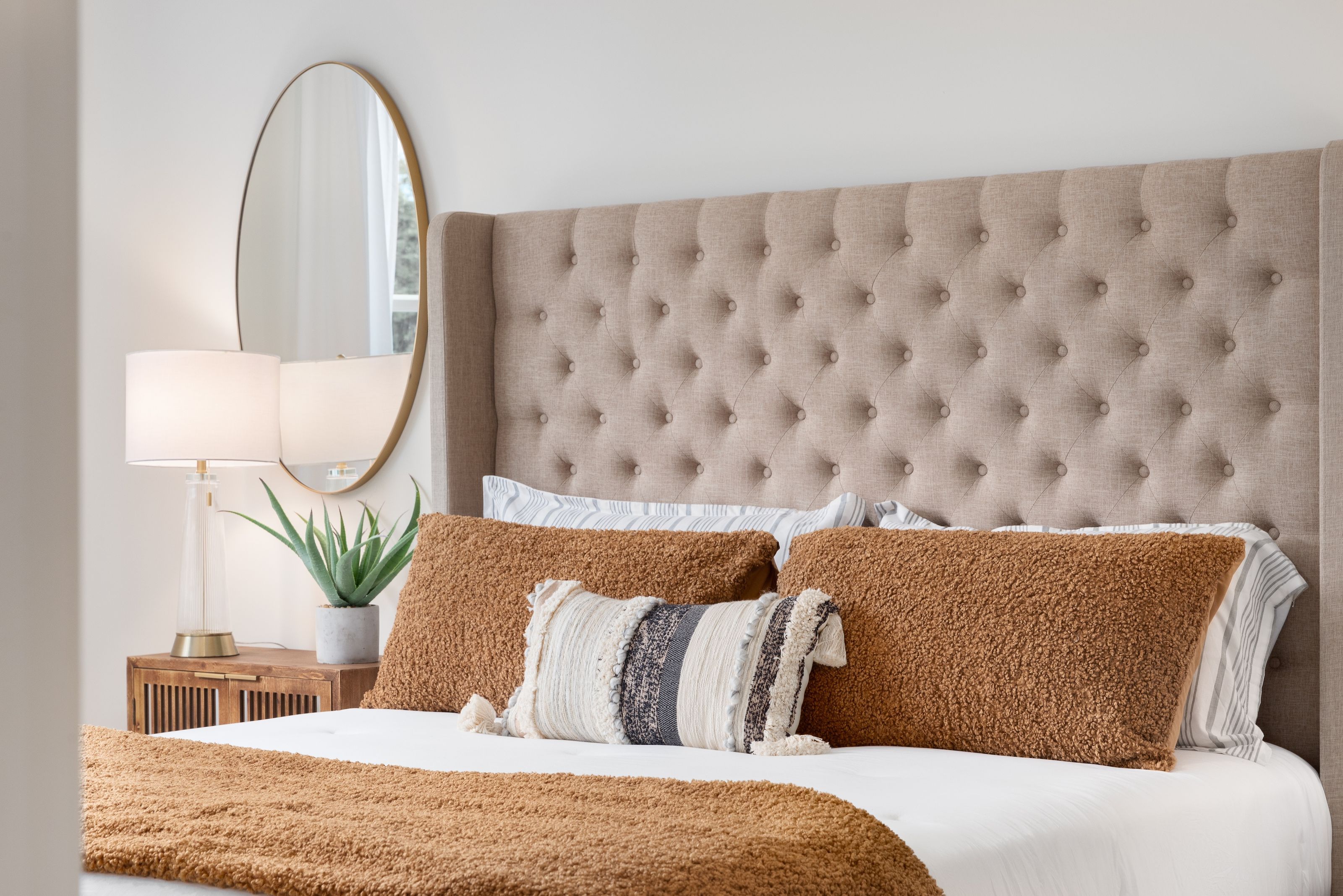 Bedroom with pillows and wall irror stock image