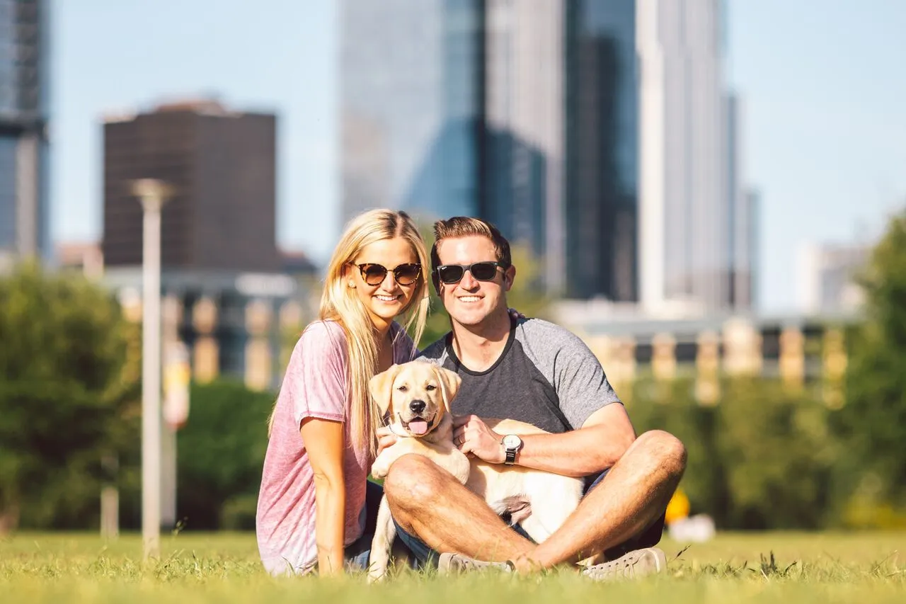 smiling couple with their dog