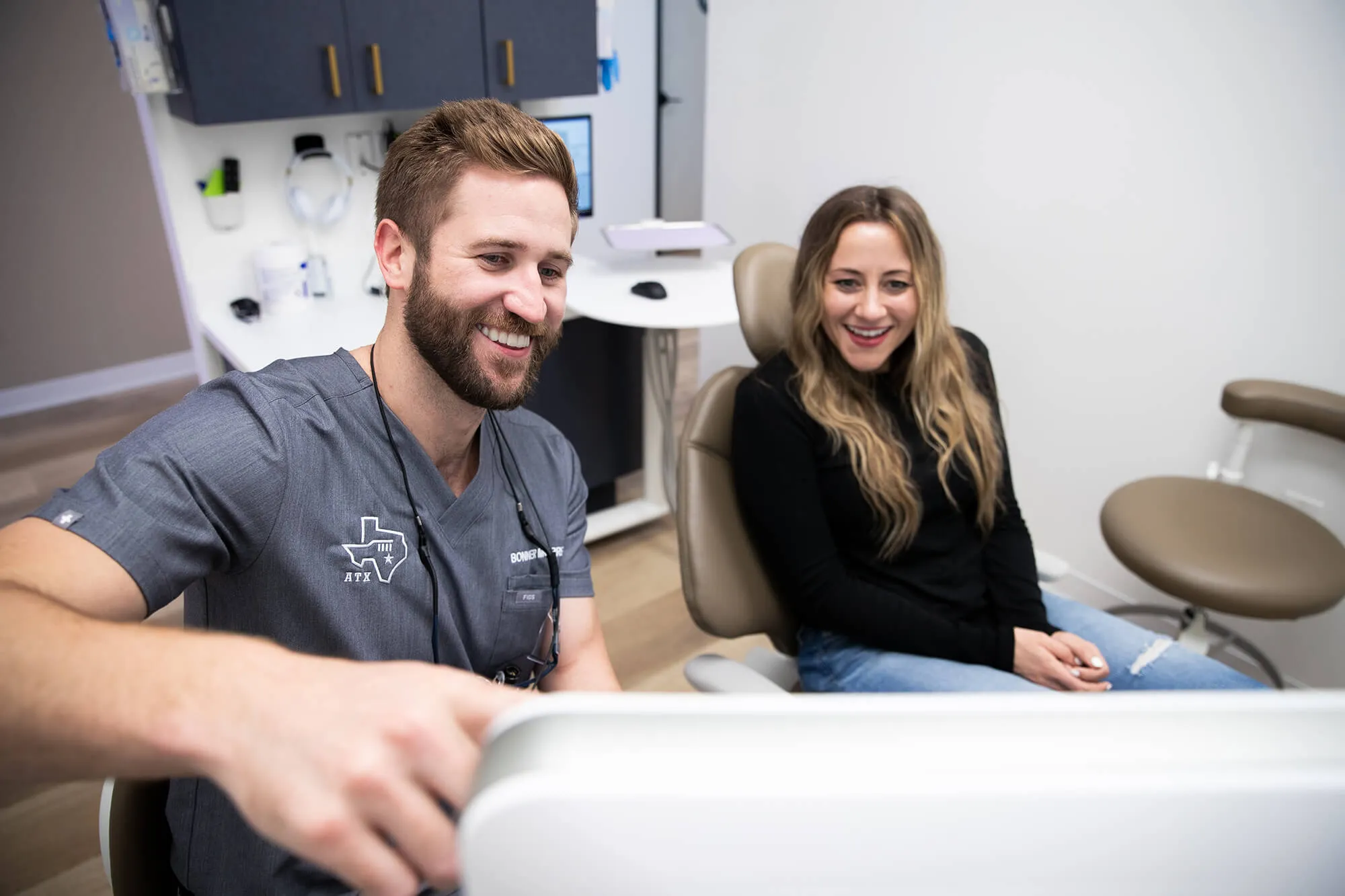 person leaning back and smiling in dental chair