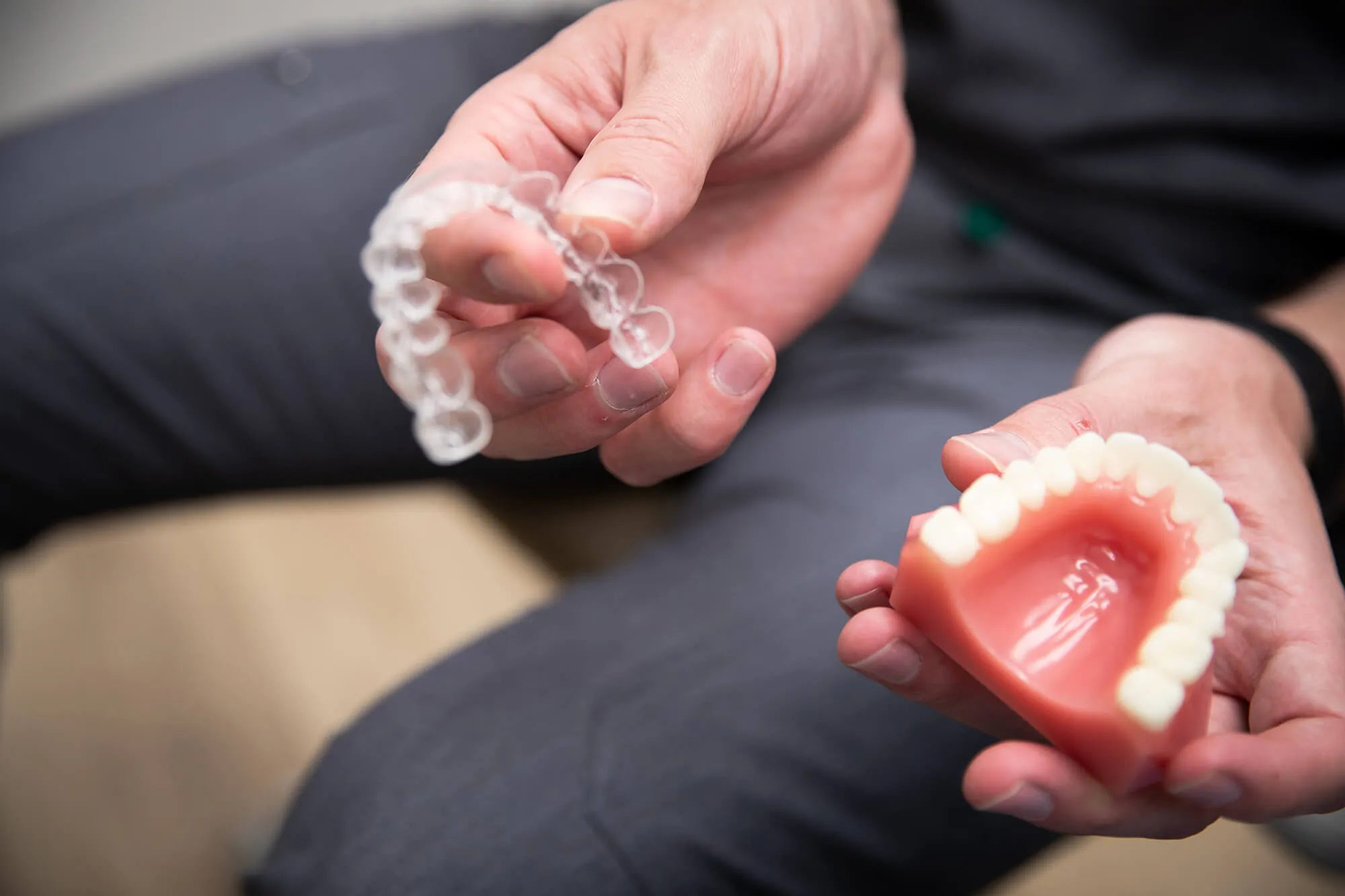 Lady putting in invisalign aligners