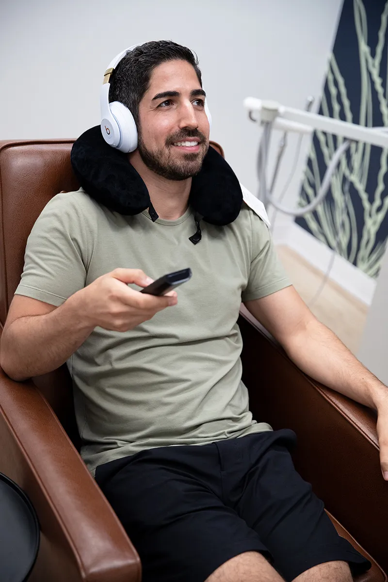 person leaning back and smiling in dental chair