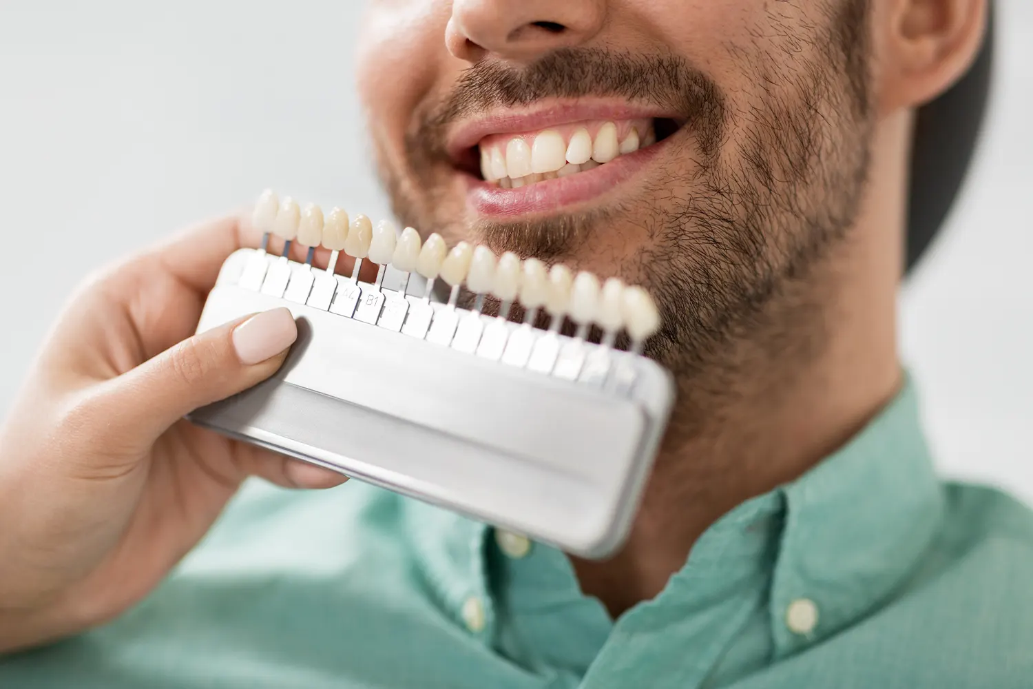 person leaning back and smiling in dental chair