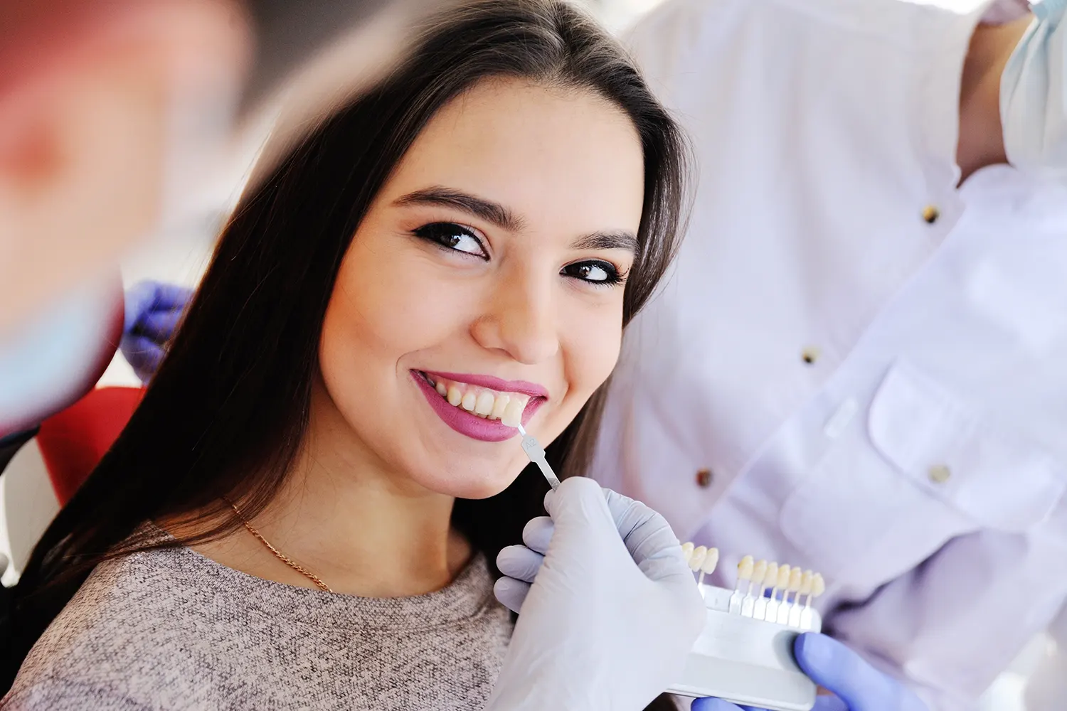 person leaning back and smiling in dental chair
