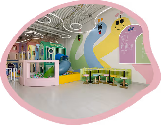 Bright indoor kids play area with colorful walls, snake murals, seating, and climbing structures.