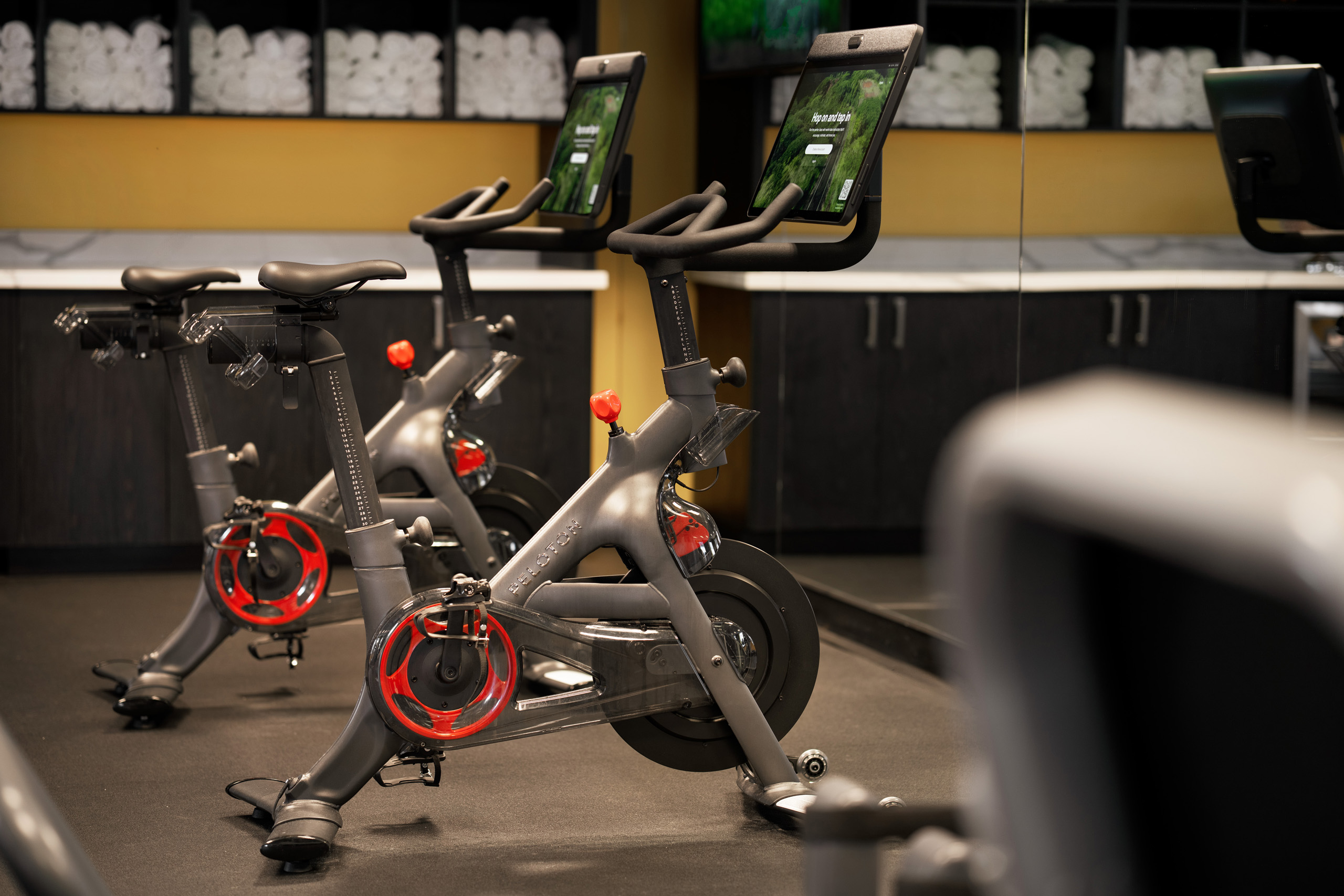 Peloton stationary bikes in hotel fitness center.