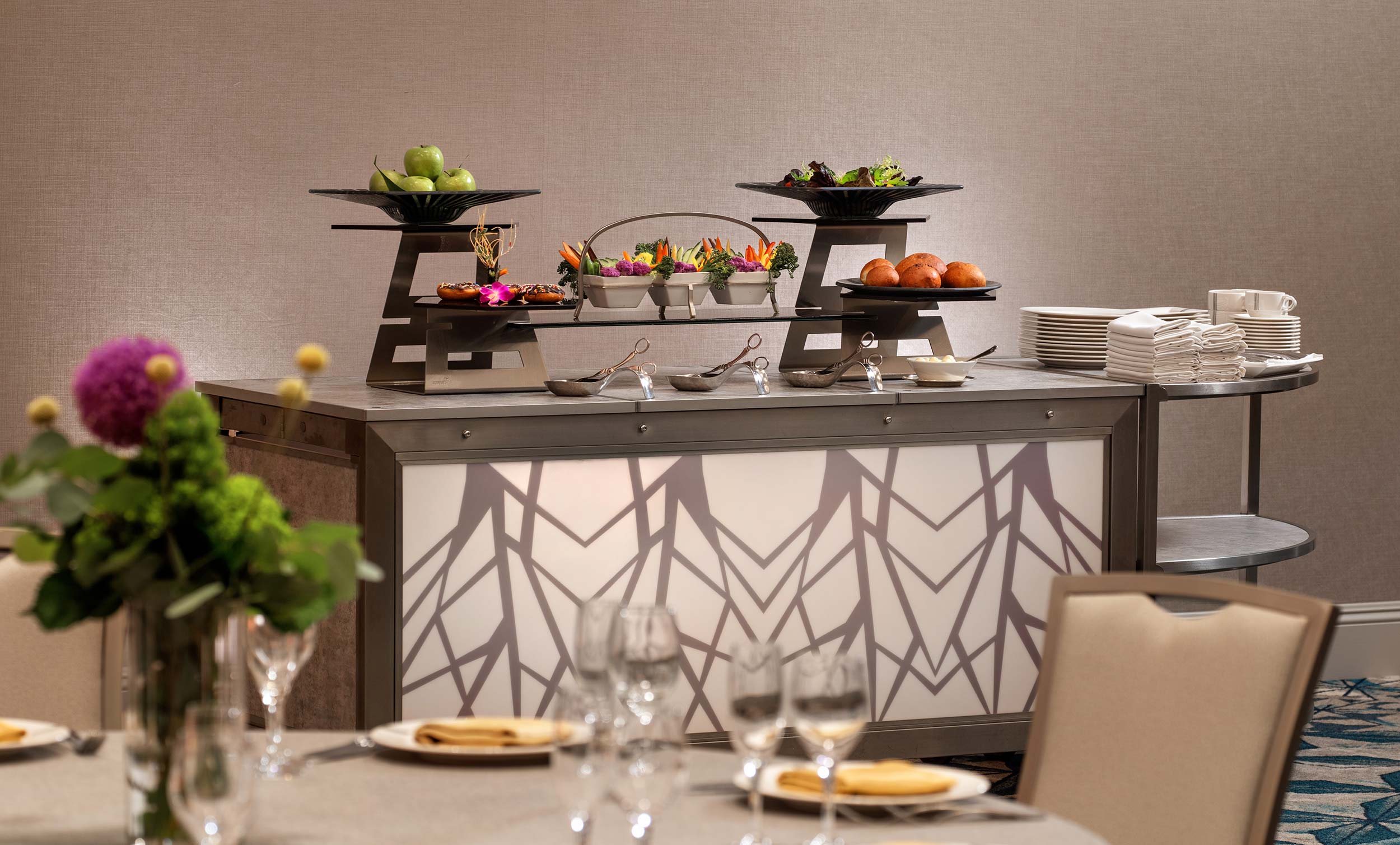 Catering buffet with salads, fruit, and pastries.