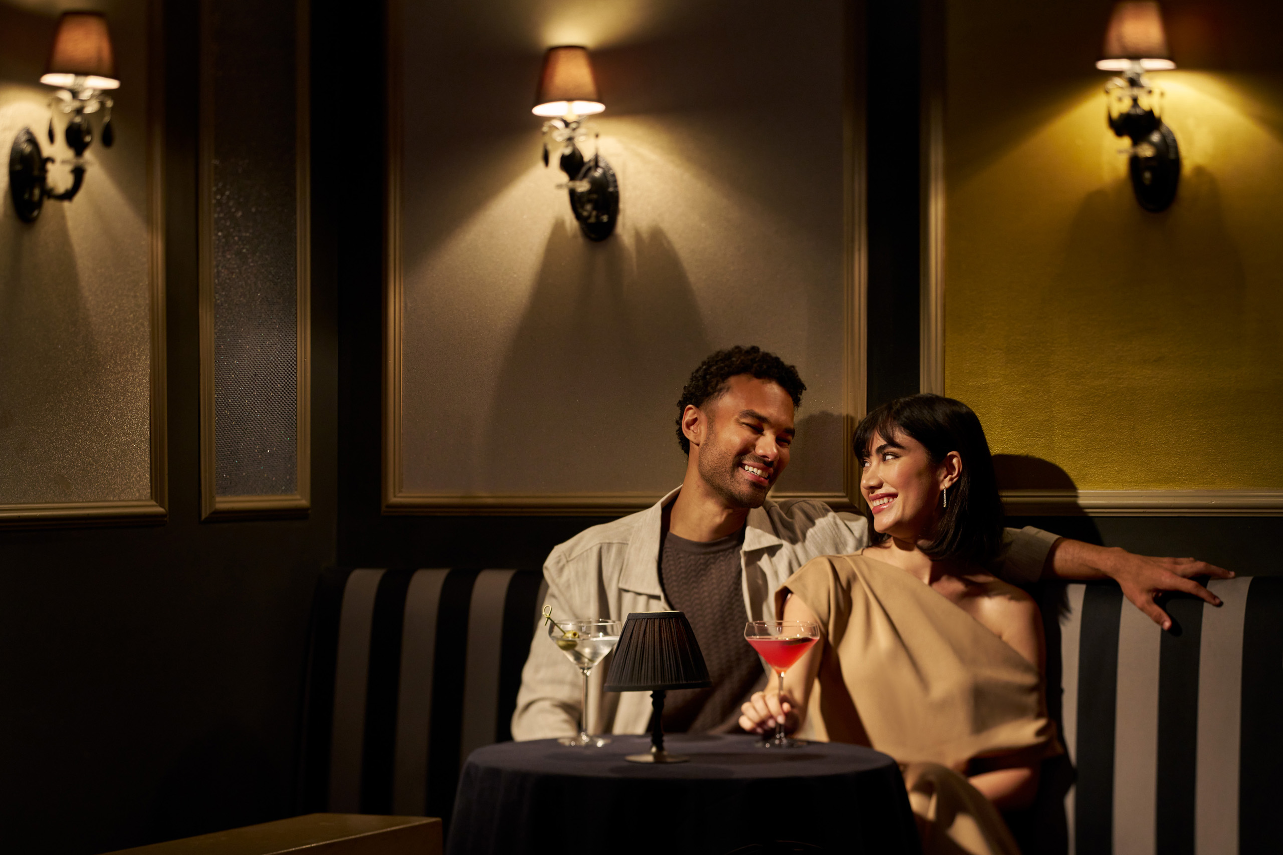 Couple enjoying cocktails at intimate lounge table