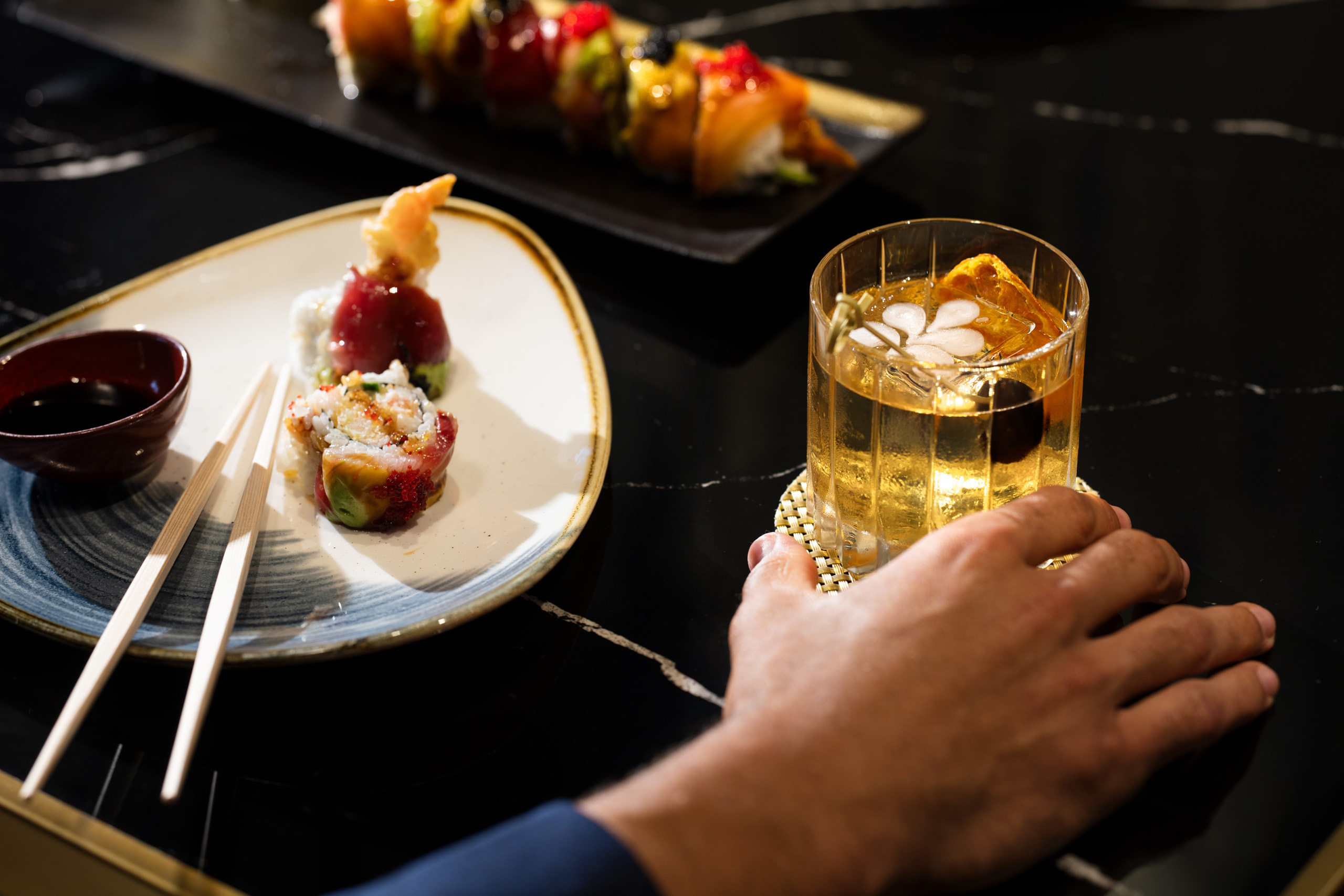 Cocktail beside sushi and chopsticks