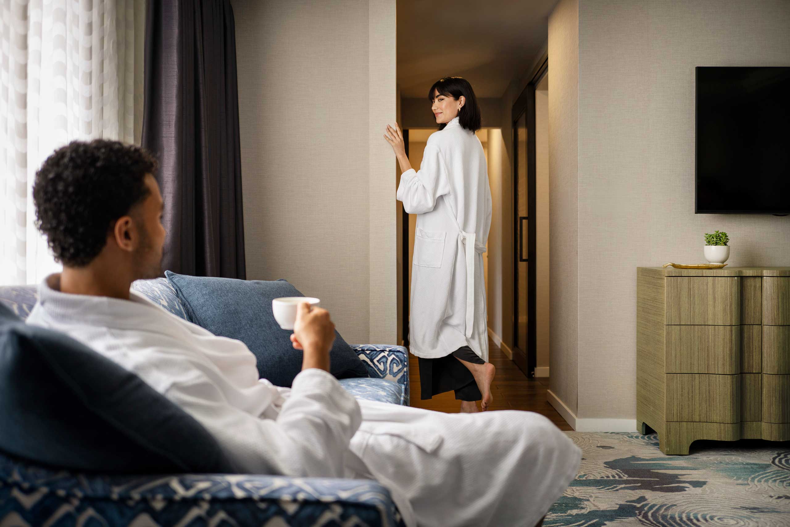 Guest relaxing in robe with morning coffee