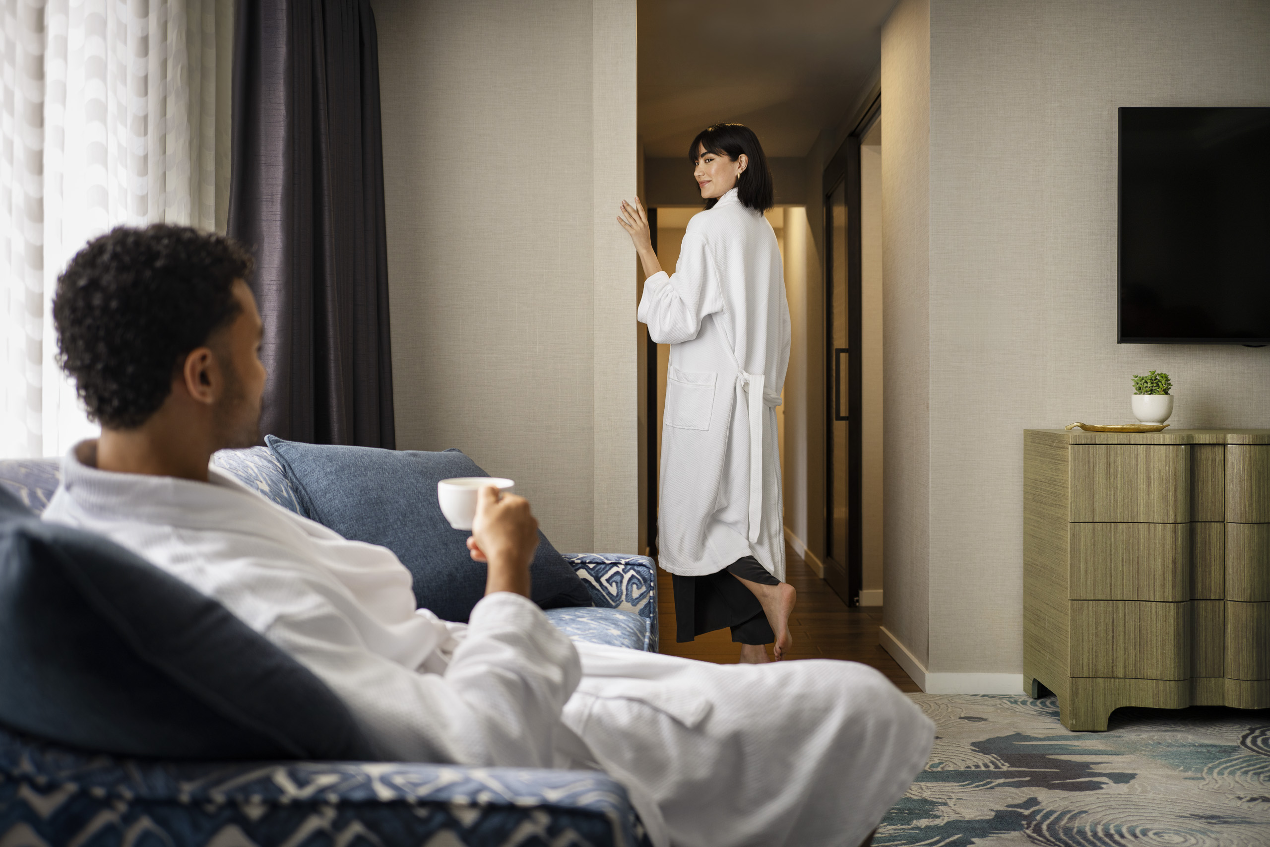 Guest relaxing in robe with morning coffee