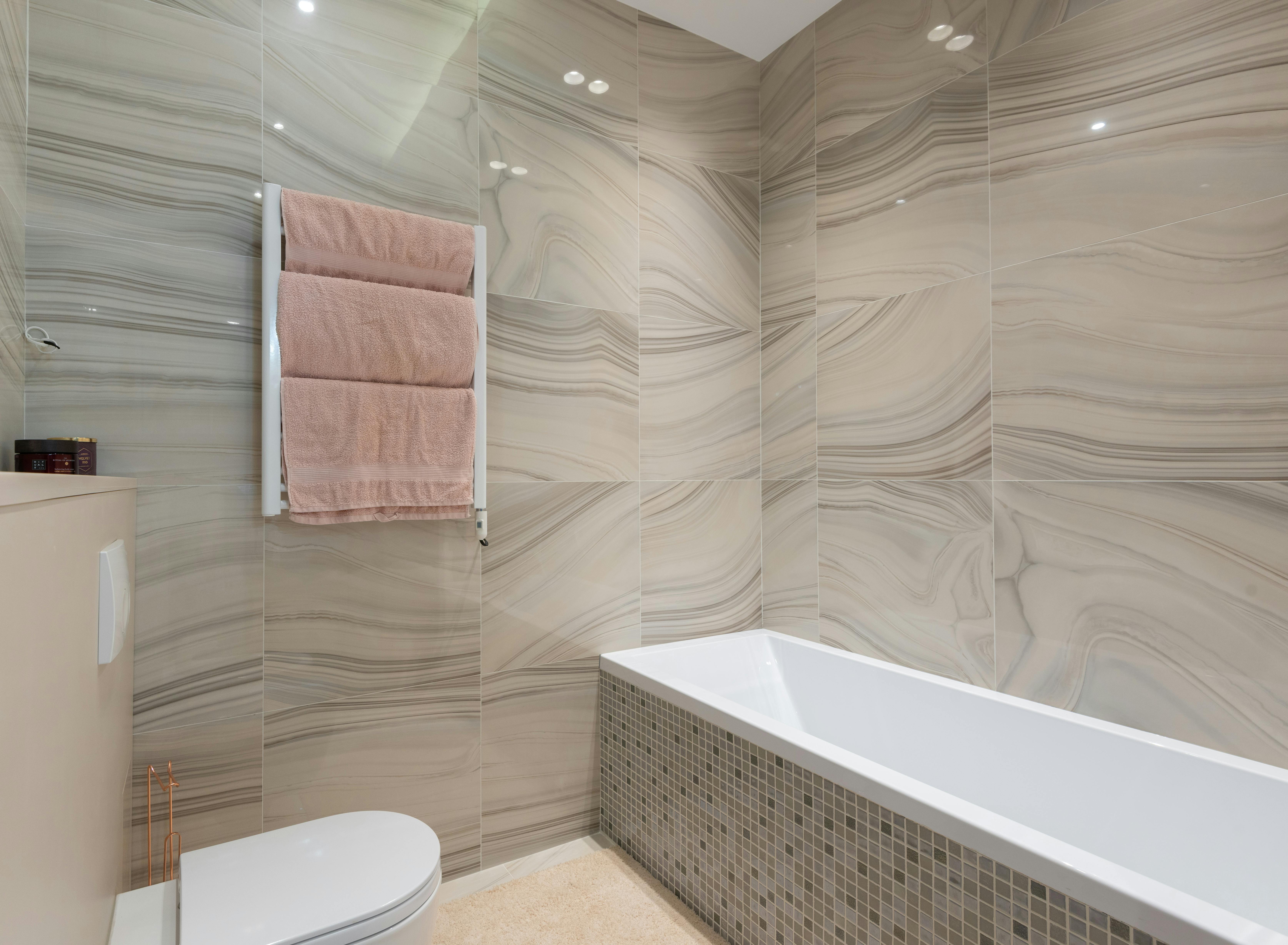 Accessible tub-shower with grab bars and transfer bench by Coastal Builders Associates