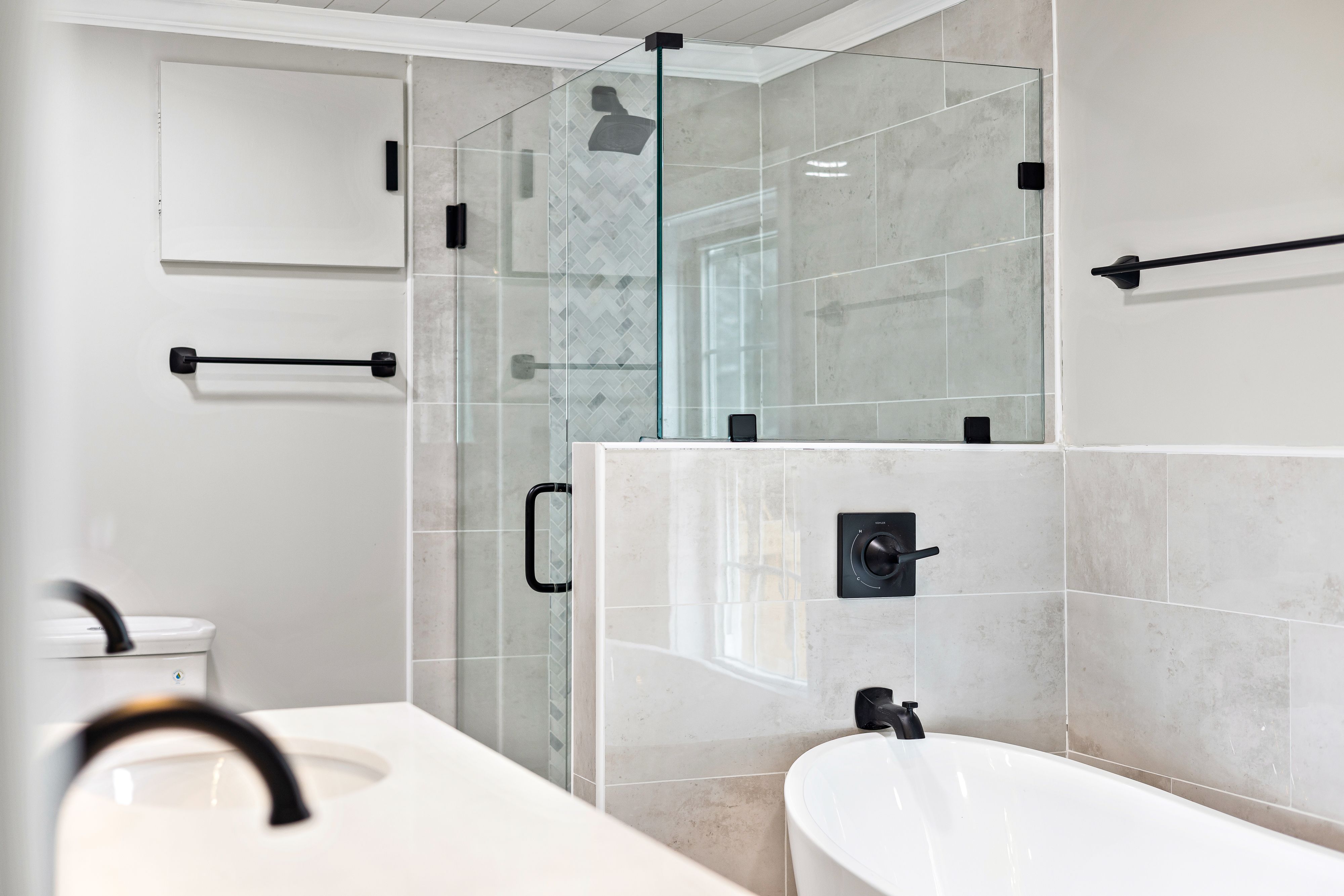 Greige full bathroom remodel with shaker vanity and marble shower by Coastal Builders Associates