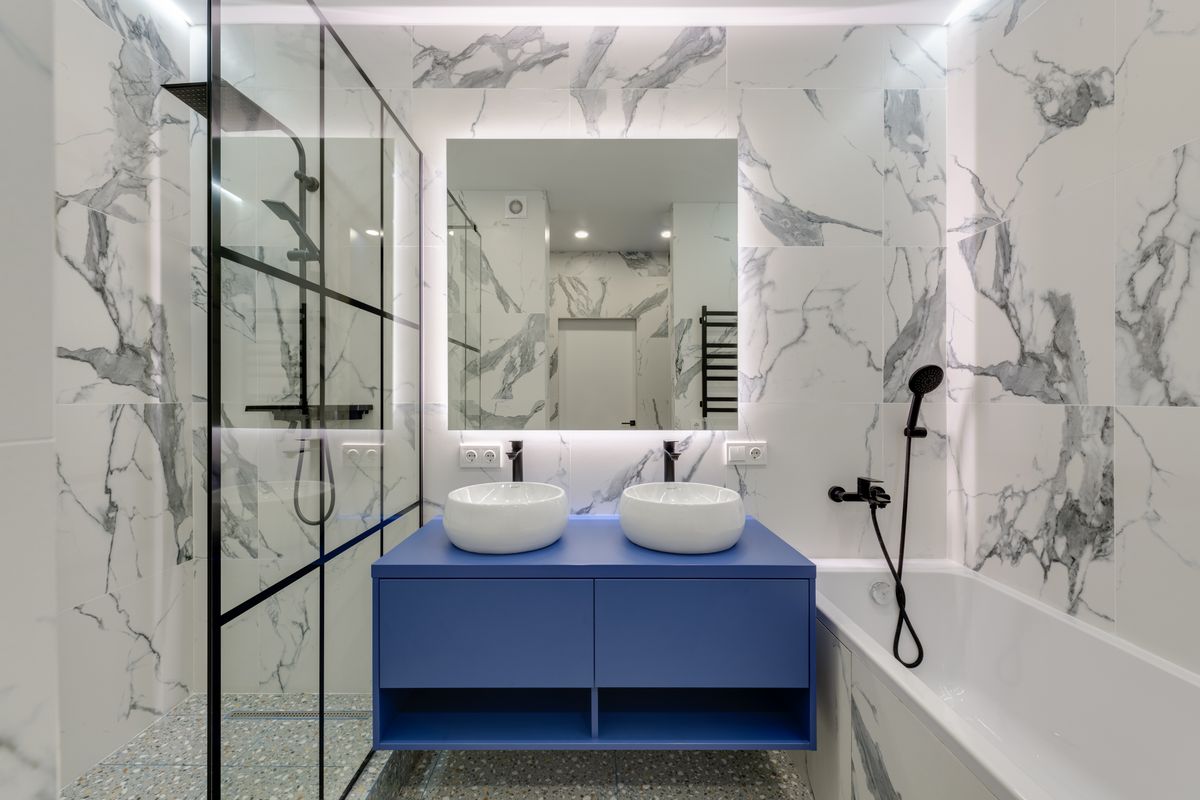 Marble bathroom with dual sinks and glass shower