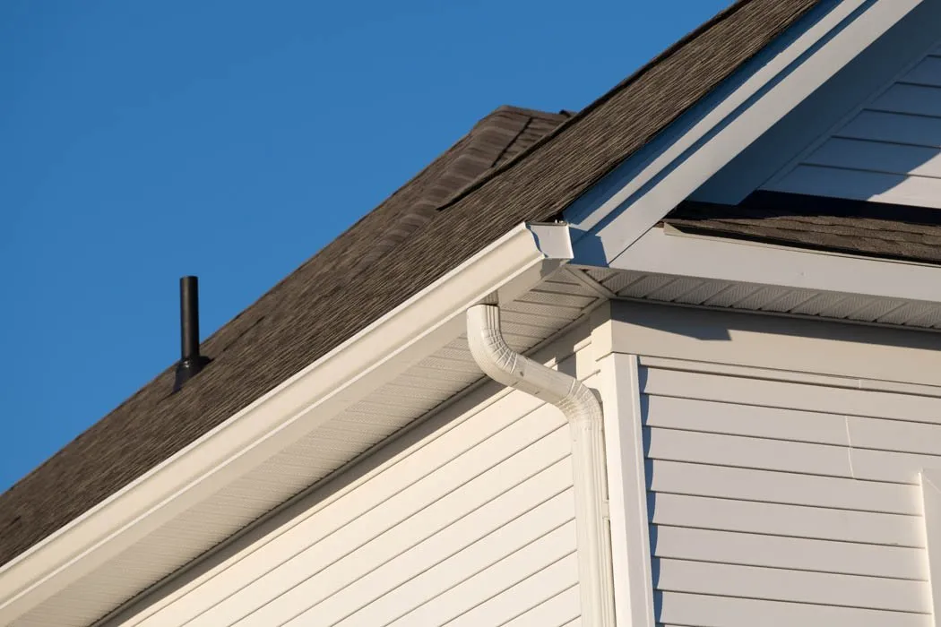 Stock photo of white vinyl rain gutters on a house