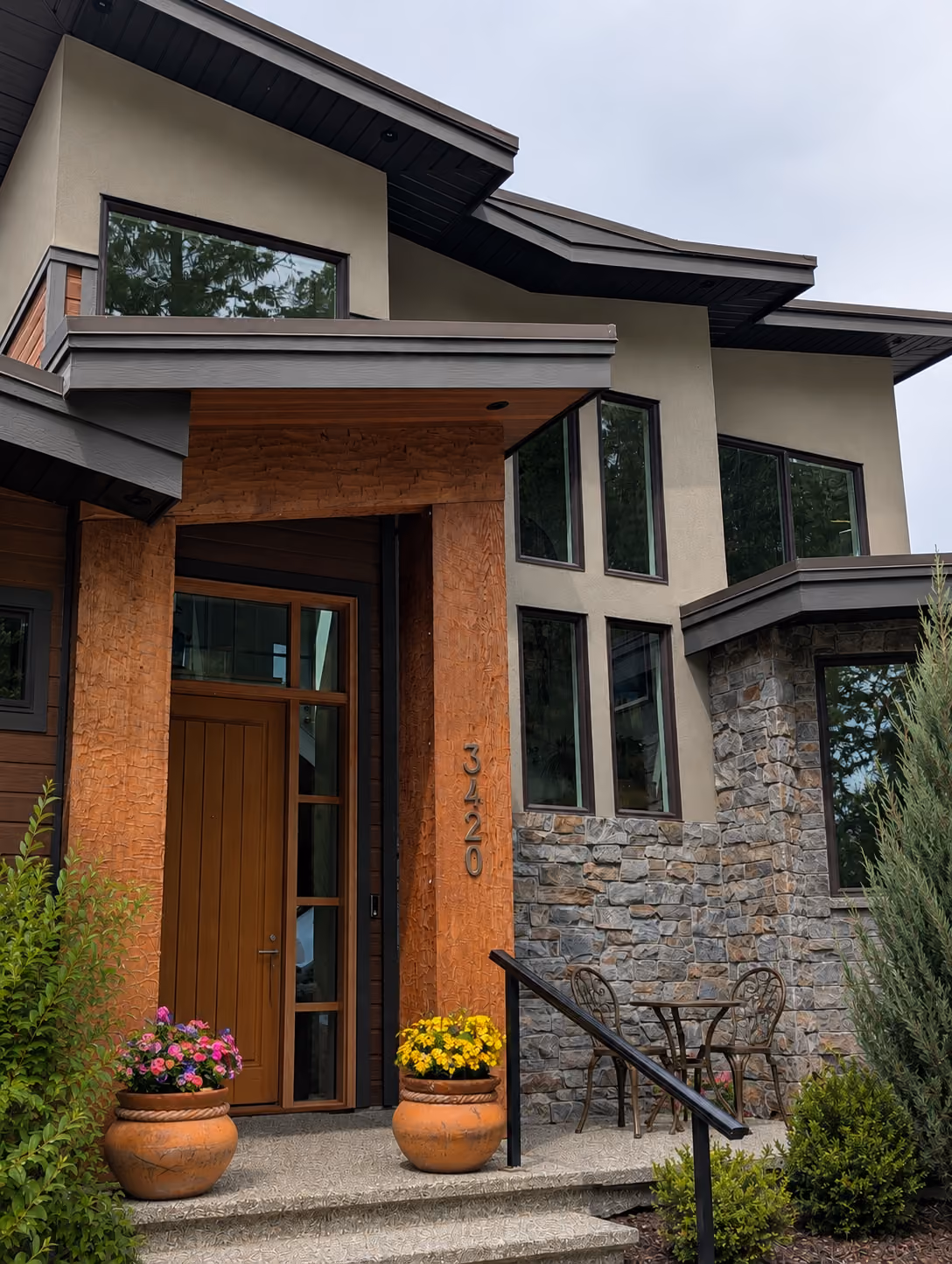Rainstone Developments modern custom home at twilight in west coast style with natural textures of wood and stone