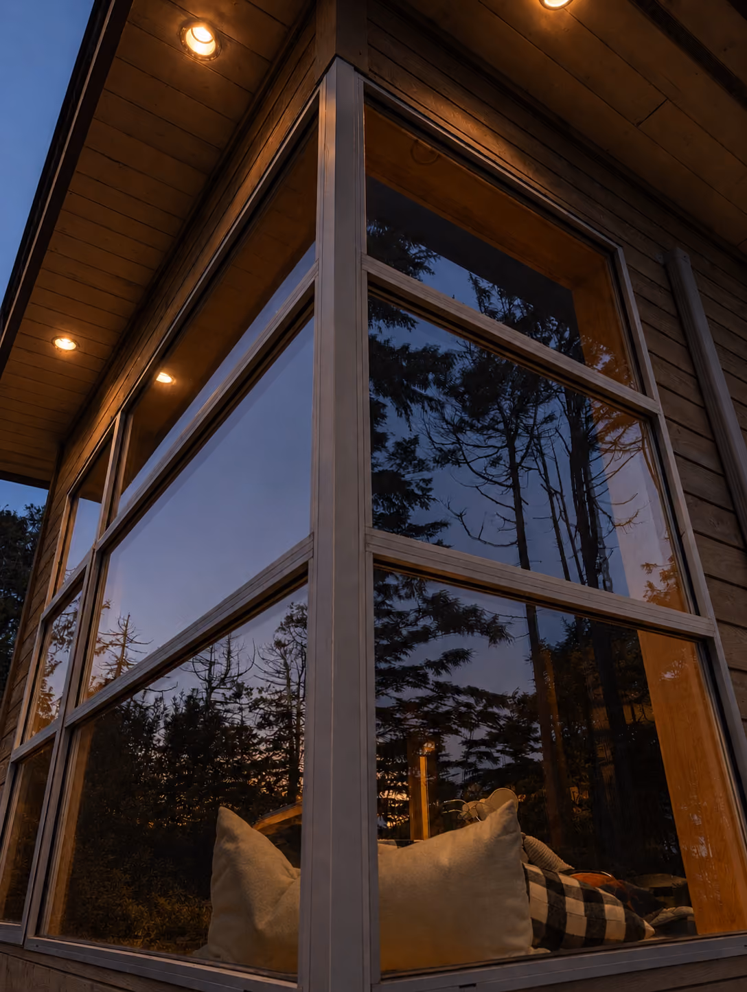 Rainstone Developments modern custom home at twilight in west coast style with big windows