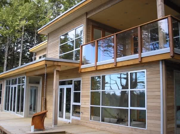 Rainstone Developments contemporary custom home in west coast style with lots of big windows and wood textures