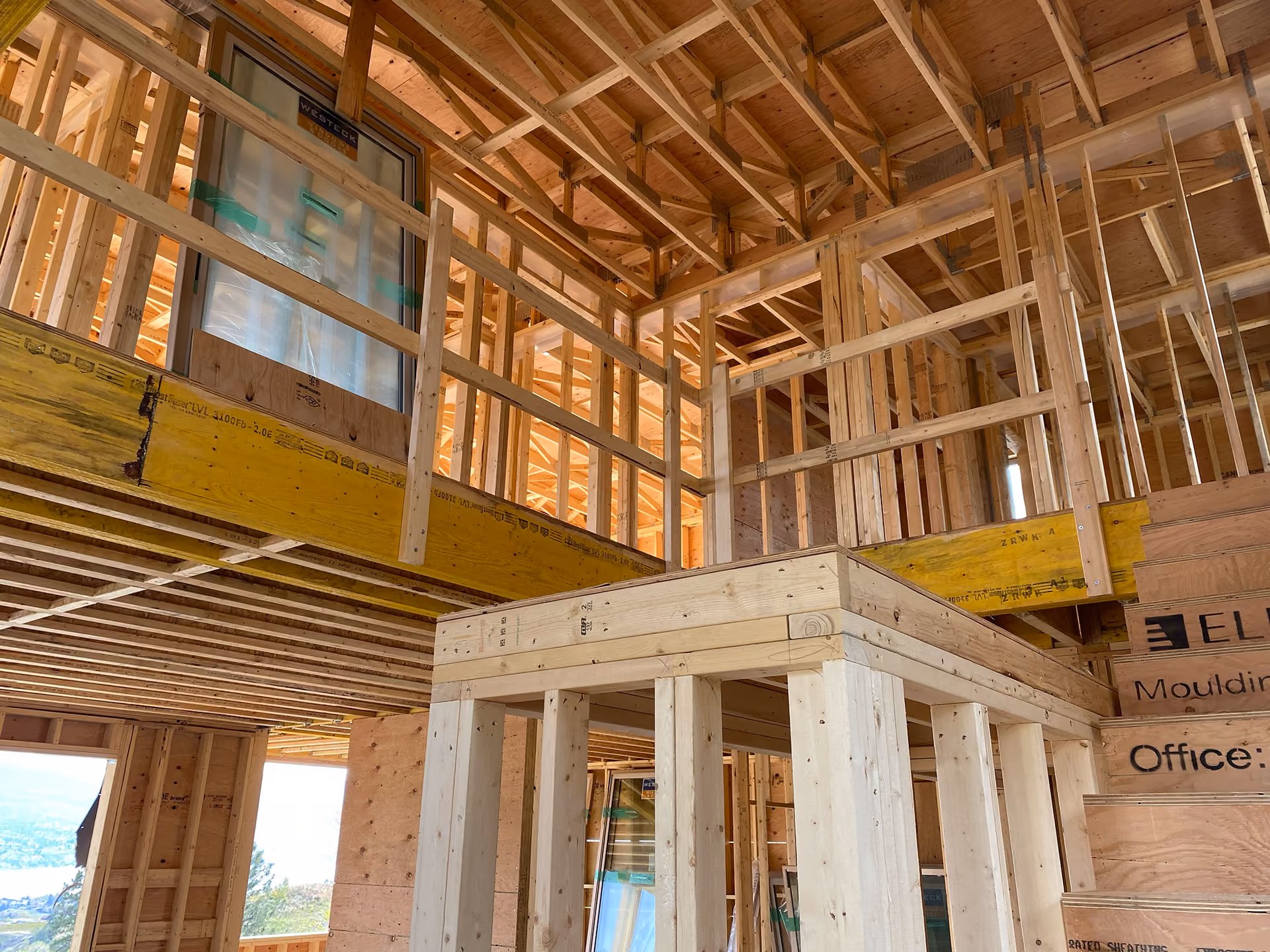 custom home under construction, at framing stage with high ceilings