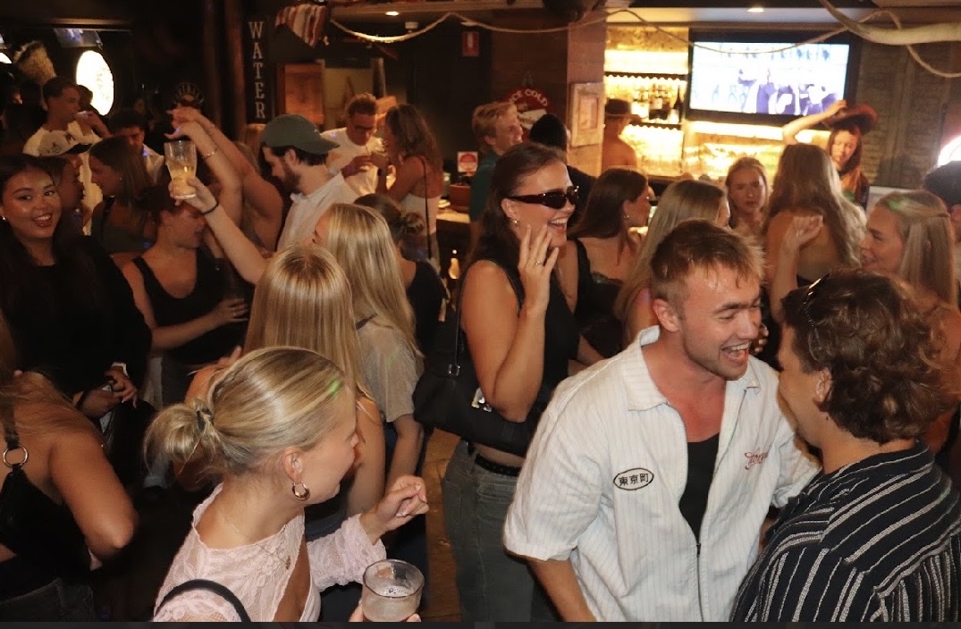 Cowboys guests celebrating with beers and cowboy hats